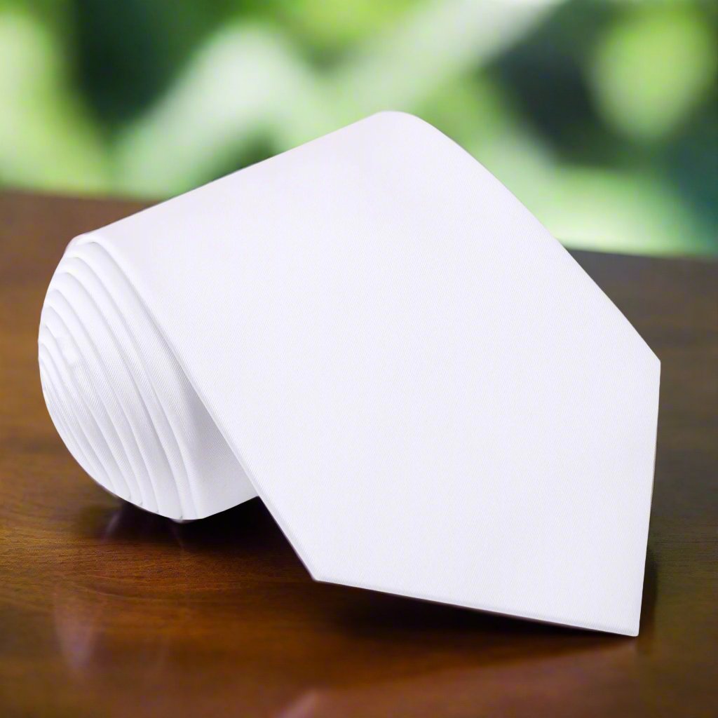 Elegant solid white silk necktie displayed on a formal shirt for weddings