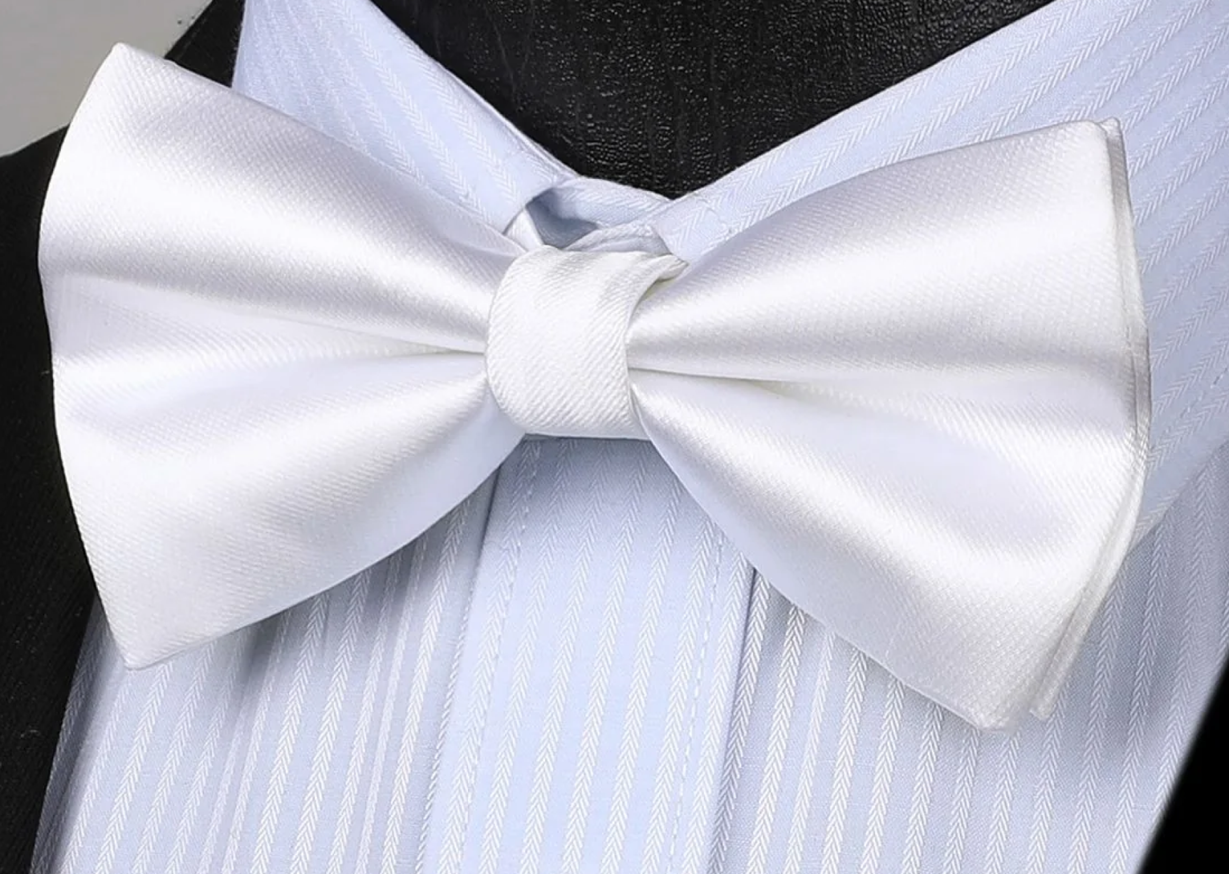 Black pre-tied tuxedo bow tie worn with a classic tuxedo suit
