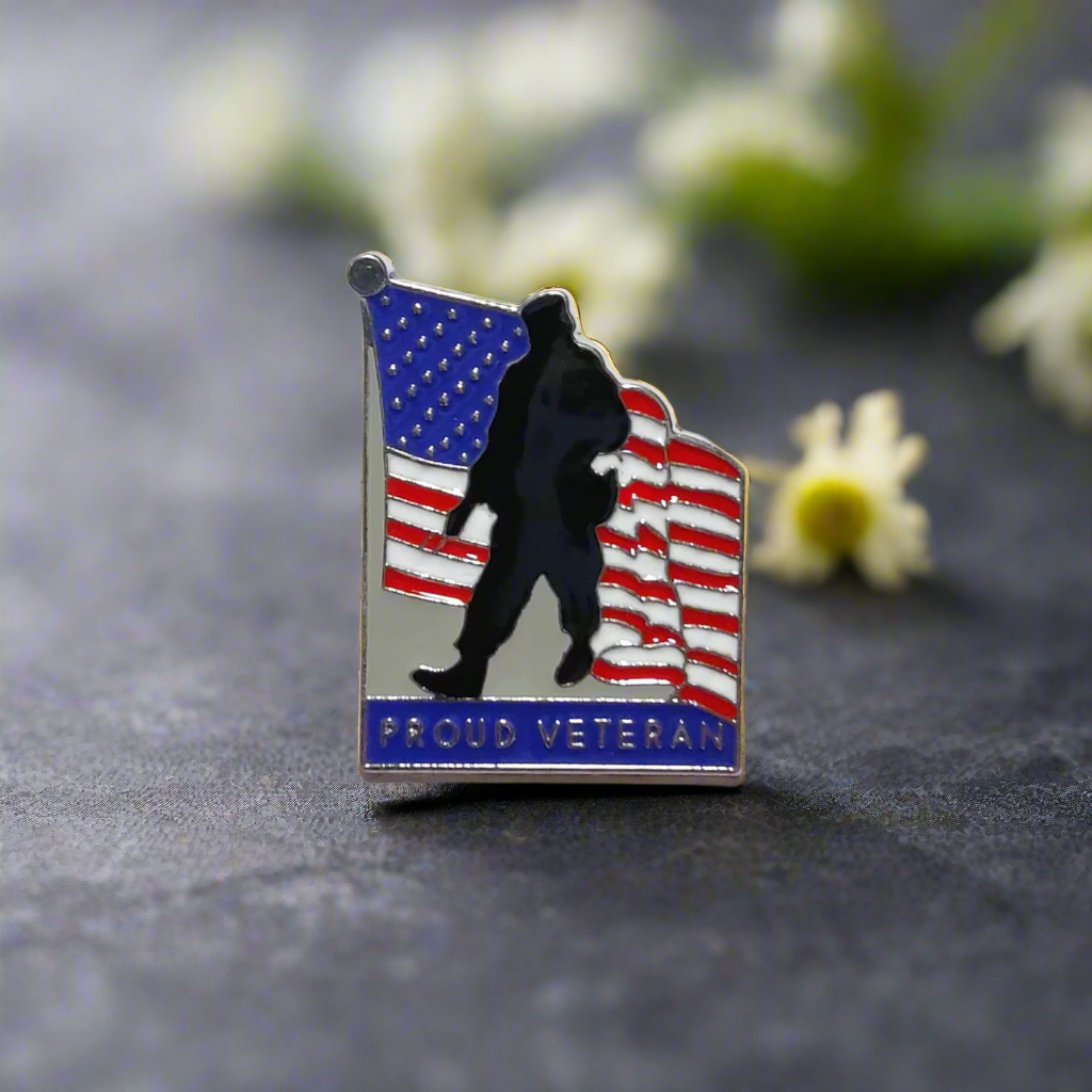 Soldier American flag pin displayed on a navy blue suit lapel.