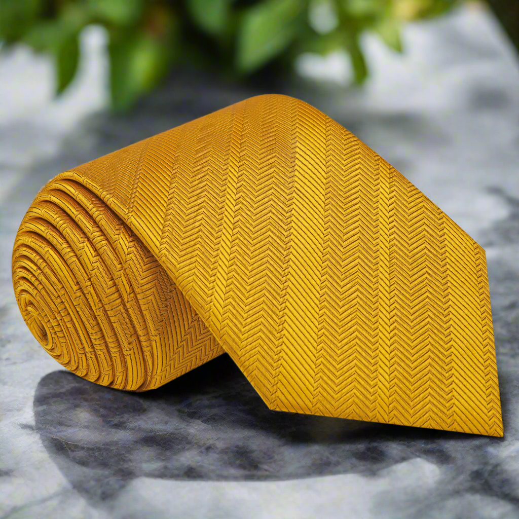 Close-up of luxurious golden amber silk necktie with polished finish.