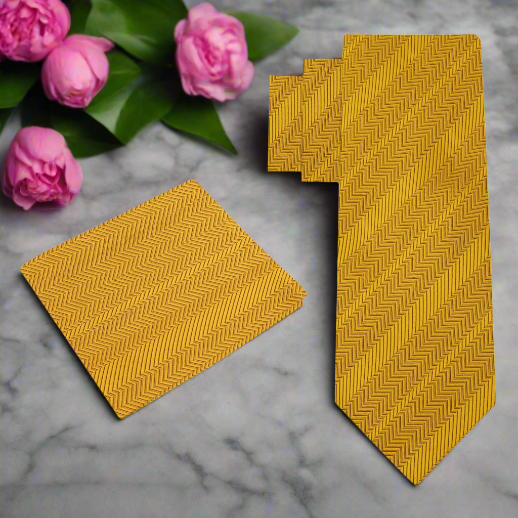 Close-up of luxurious golden amber silk necktie with polished finish.