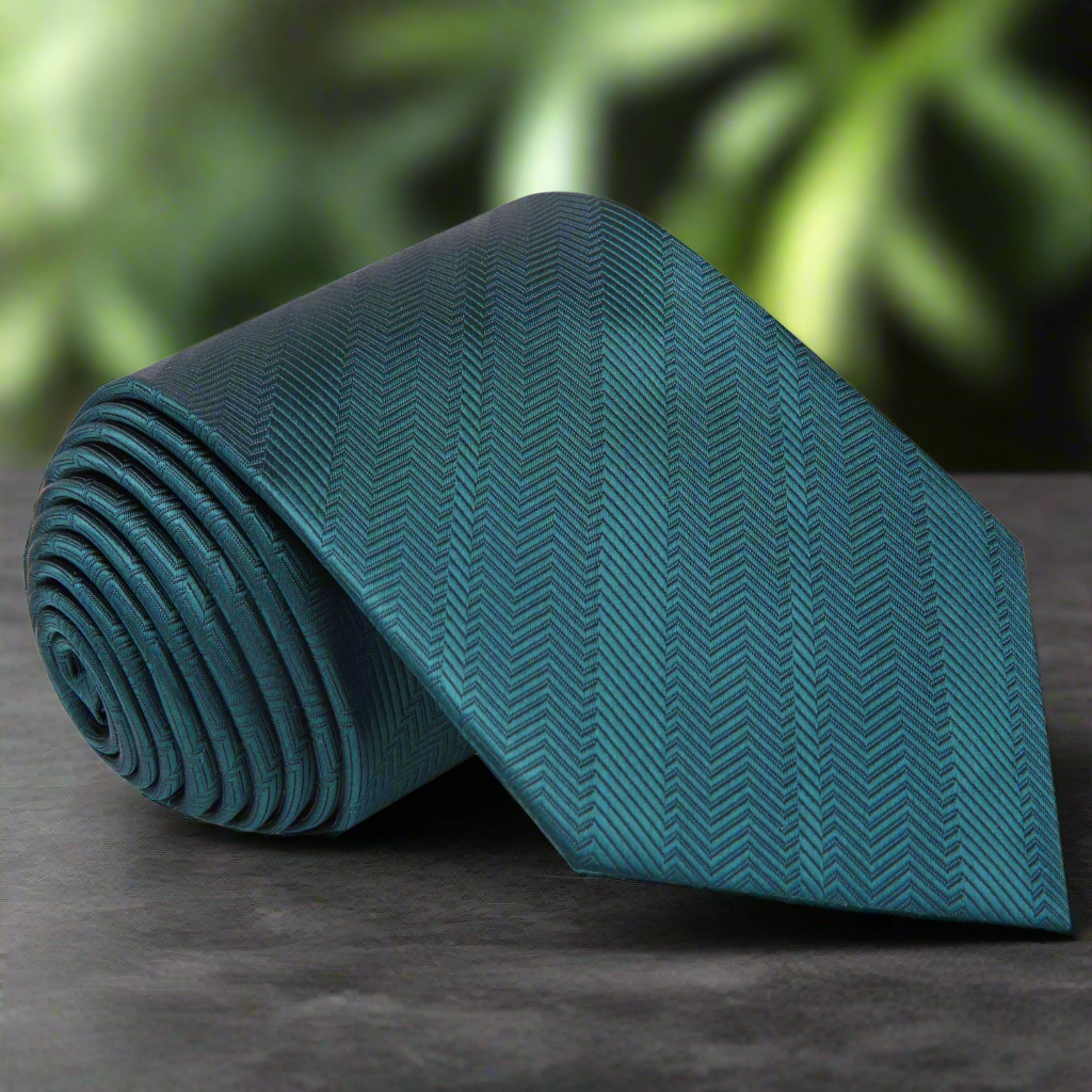 Elegant deep teal silk necktie on a formal shirt, showcasing its rich color and sheen.