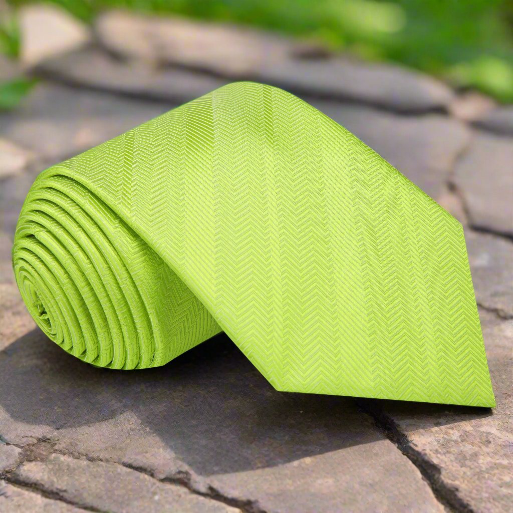 Close-up of a vibrant lime green silk necktie on a mannequin, ideal for weddings