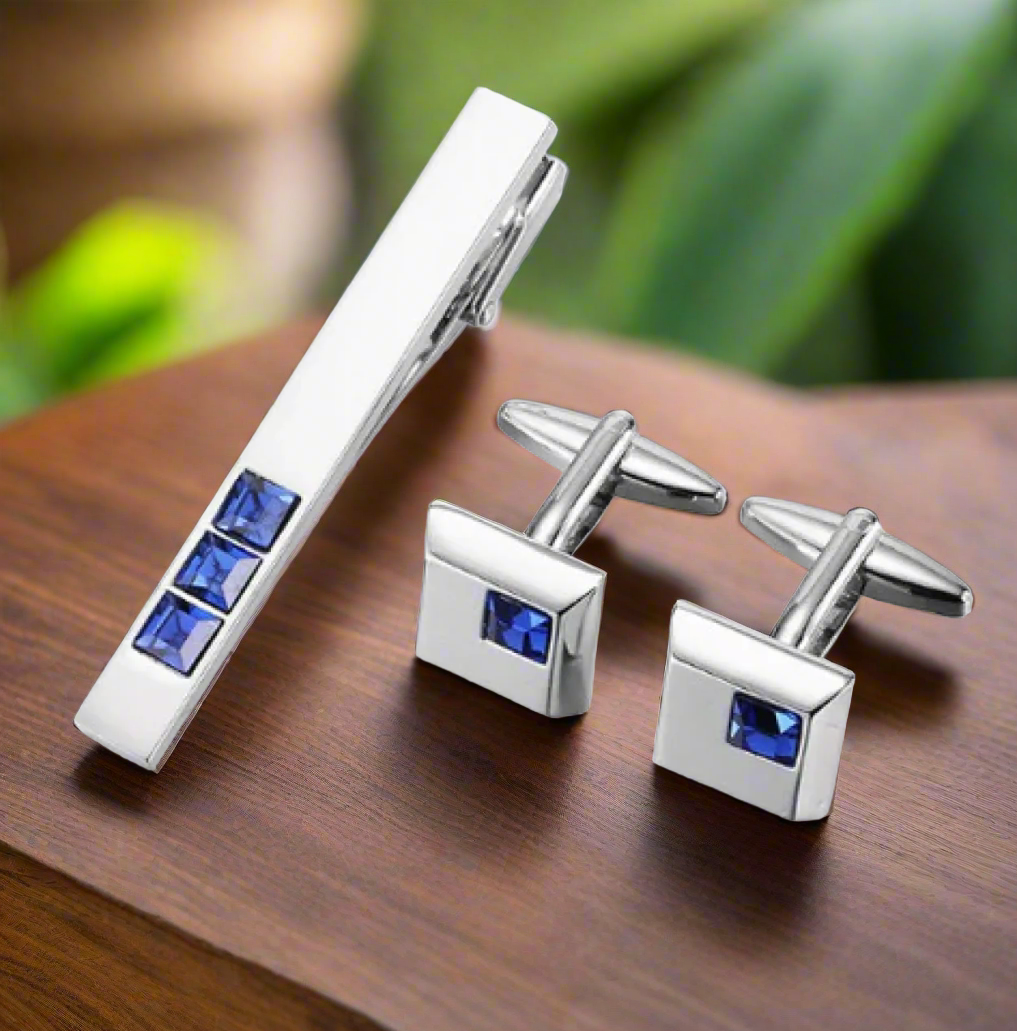 Close-up of chrome cuff links with blue square stones, perfect for formal attire