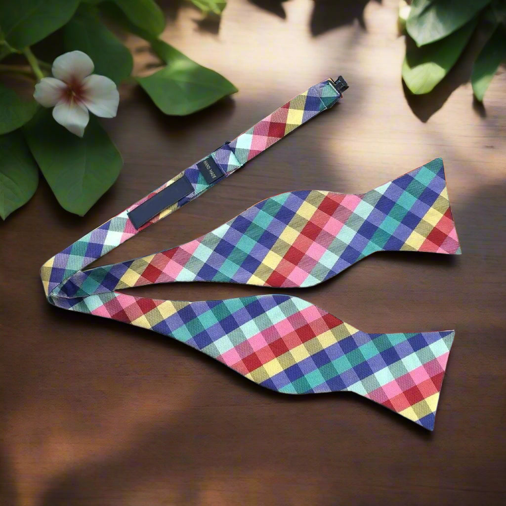 Styled outfit featuring the plaid bow tie with a white dress shirt and suit