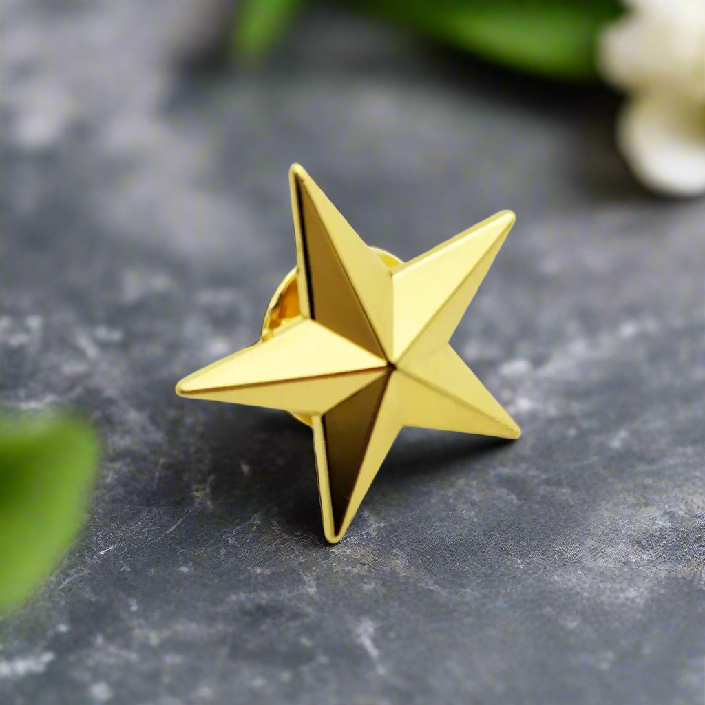 Close-up of stylish star lapel pin in gold against a dark suit.