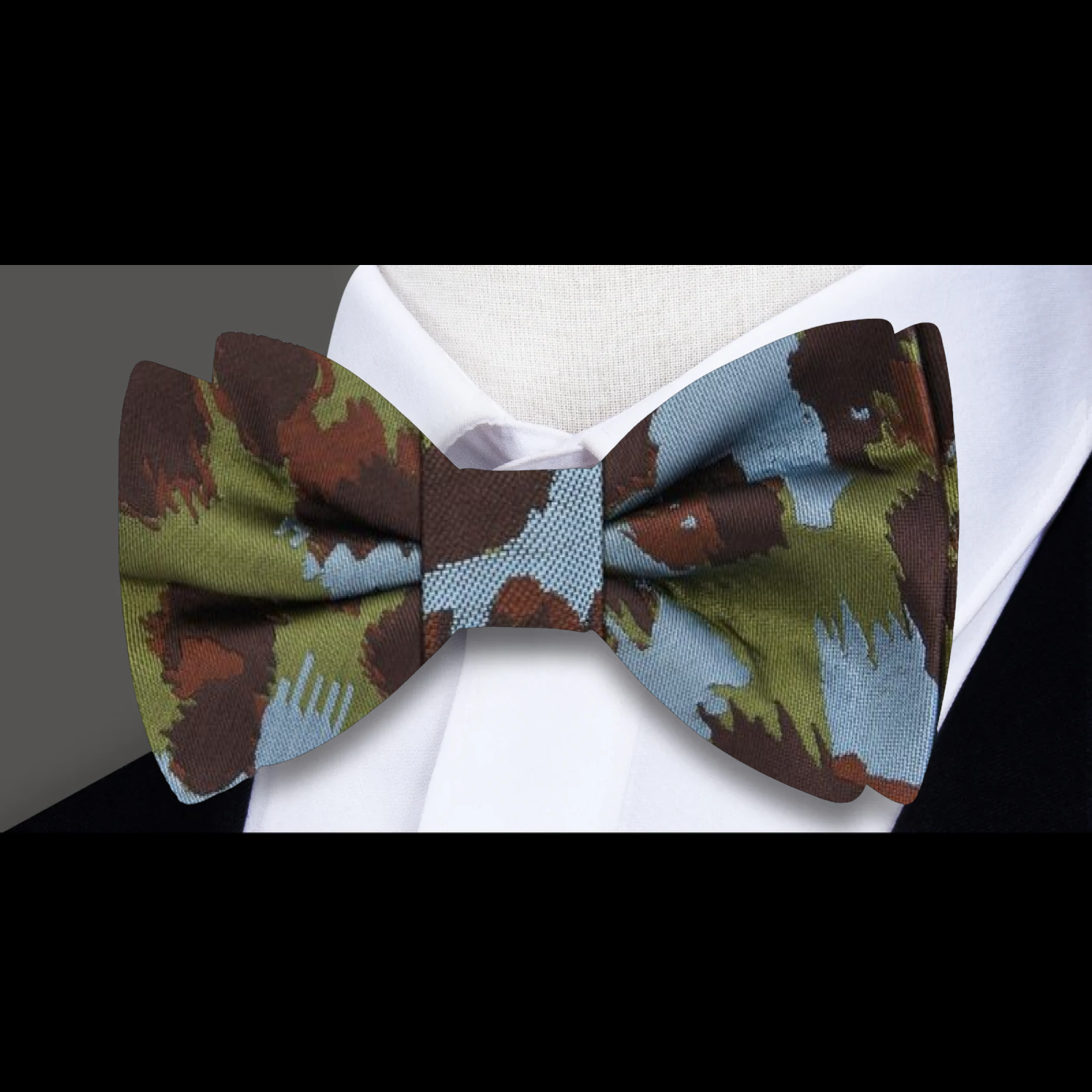 Close-up of bow tie tying process, showcasing natural silk fabric and wild pattern
