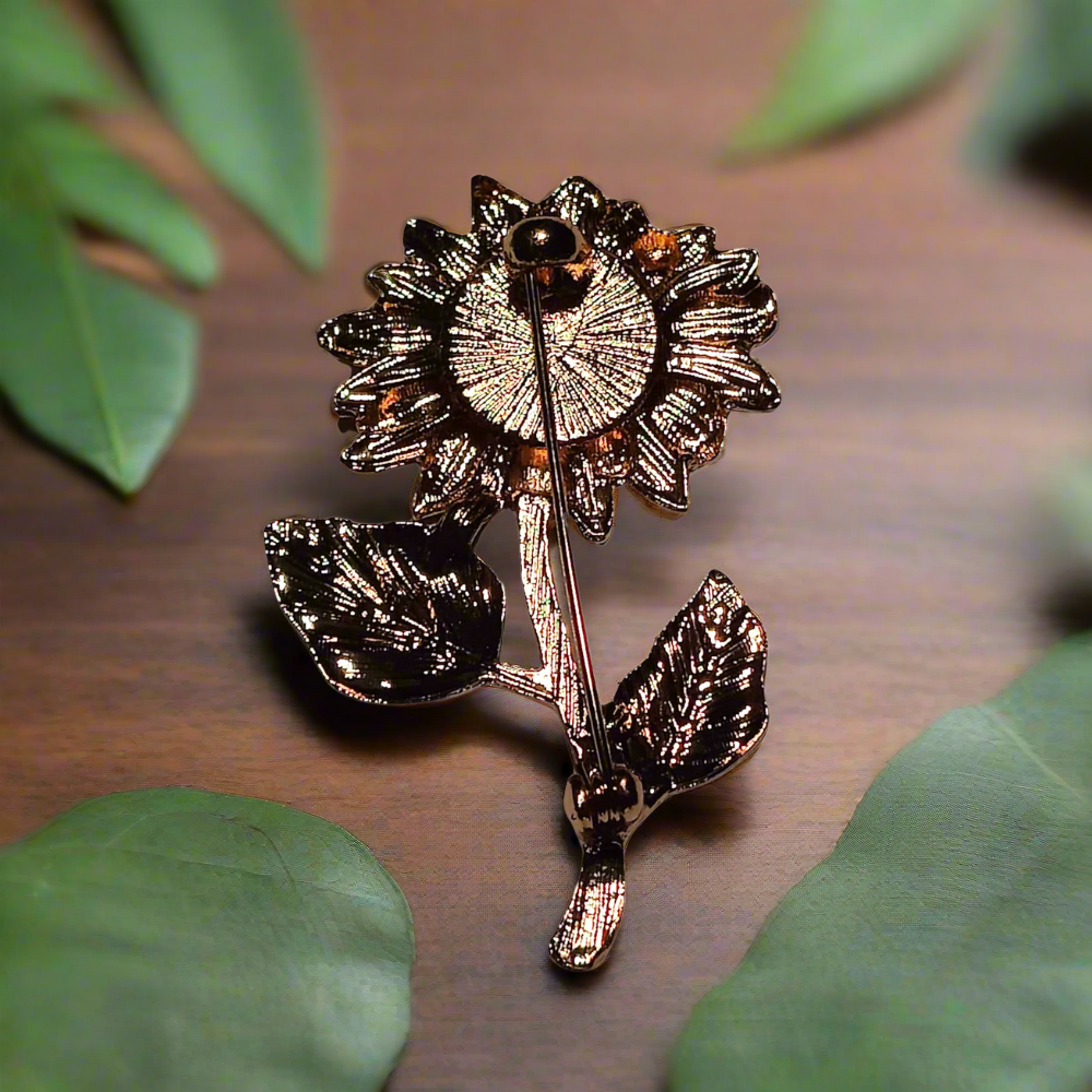Close-up of yellow sunflower lapel pin with chrome details
