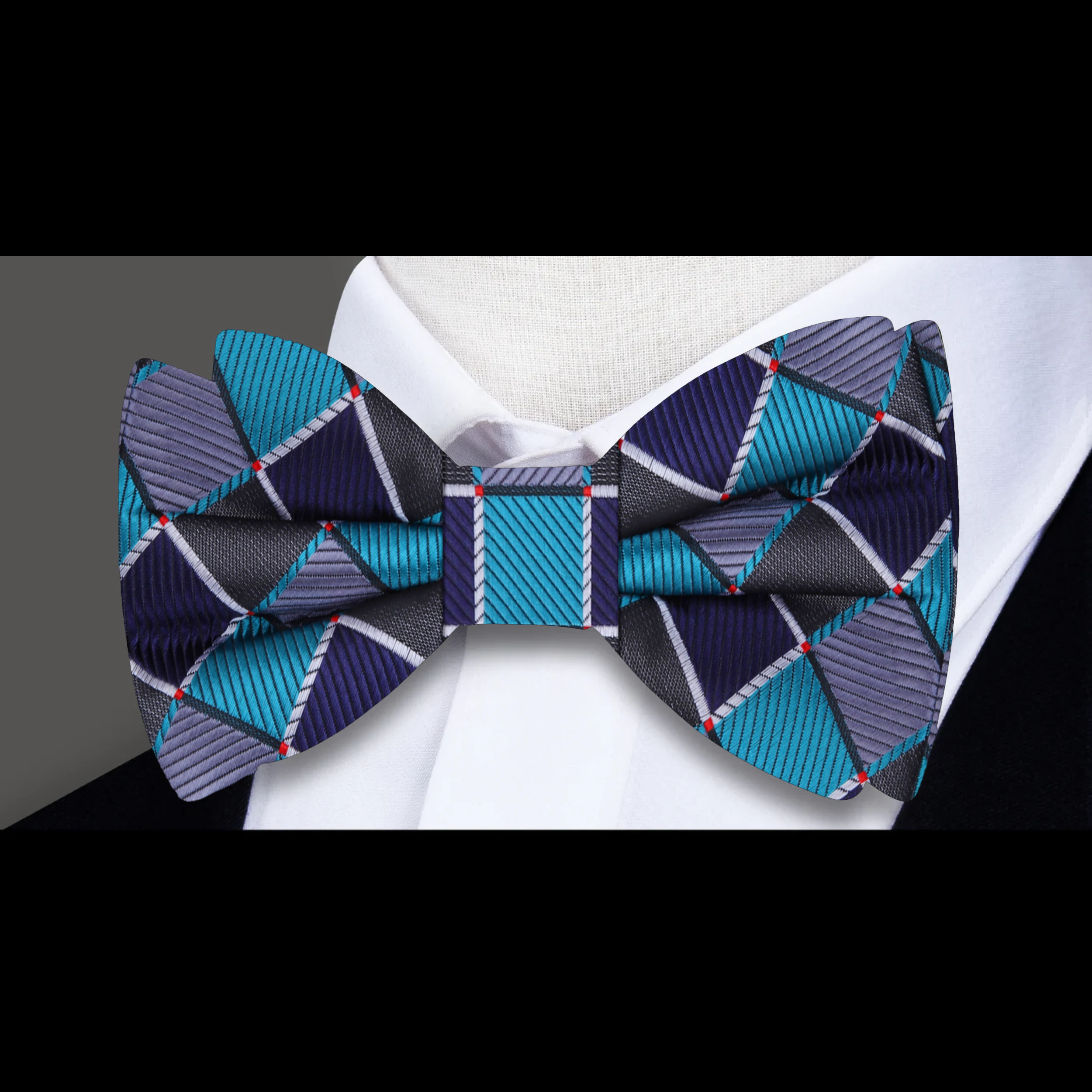 Man wearing a geometric silk bow tie with a matching pocket square, stylish and modern