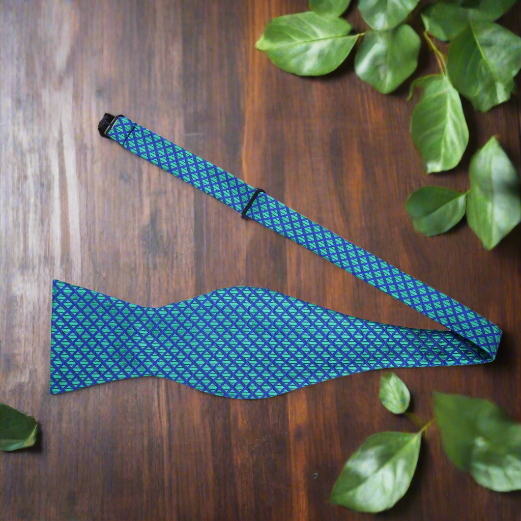 Man wearing a vibrant green geometric bow tie with a white dress shirt