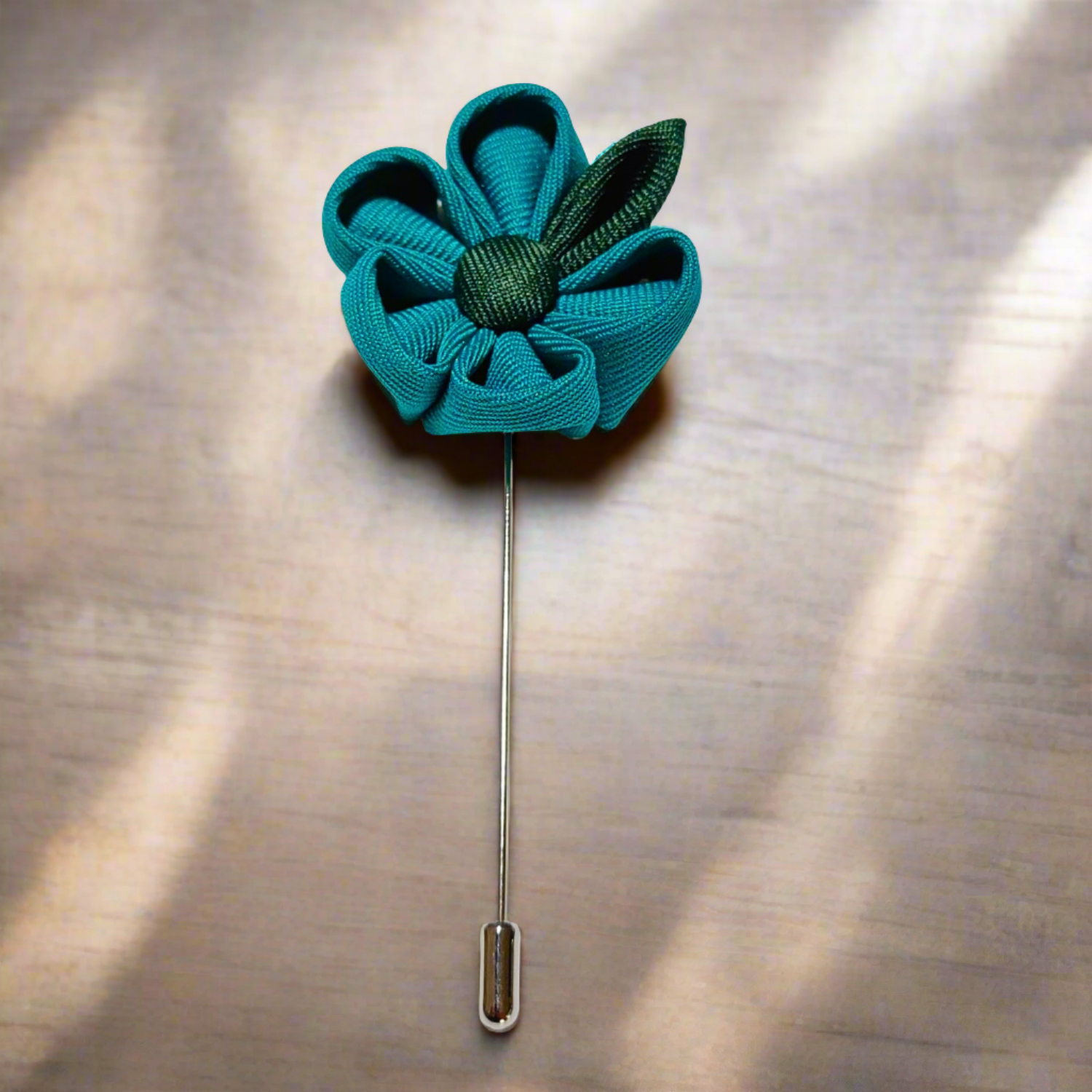 Men wearing a stylish teal and green lapel flower pin at a wedding