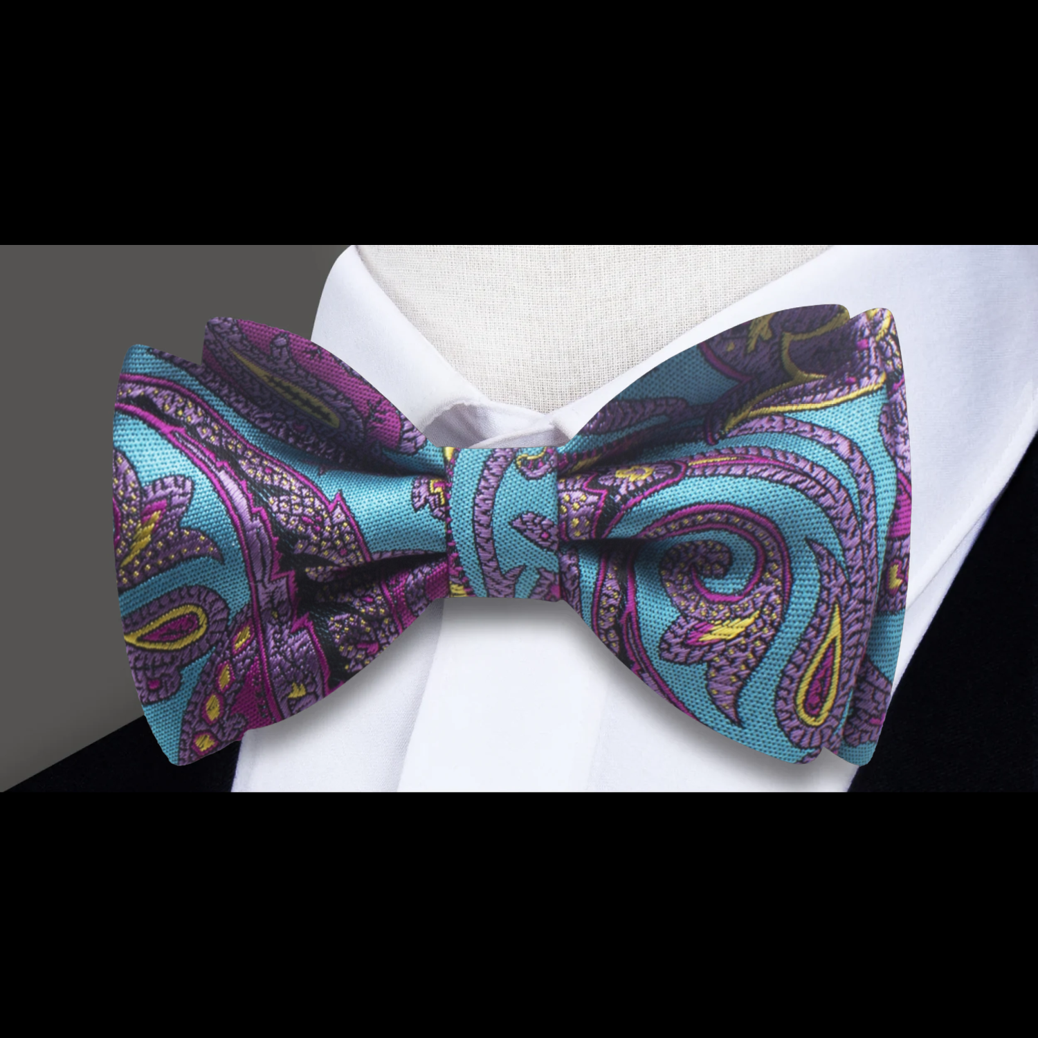 Model wearing a silk paisley bow tie at a wedding reception