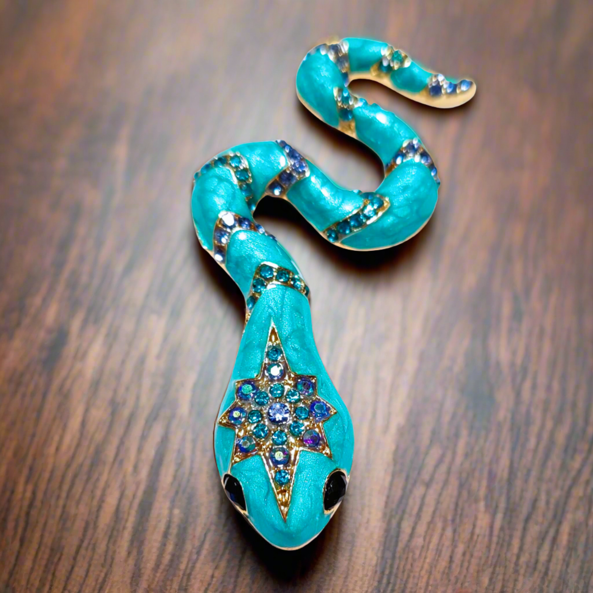 Close-up view of the luxury gemstone snake lapel pin showing vibrant colors and intricate design.