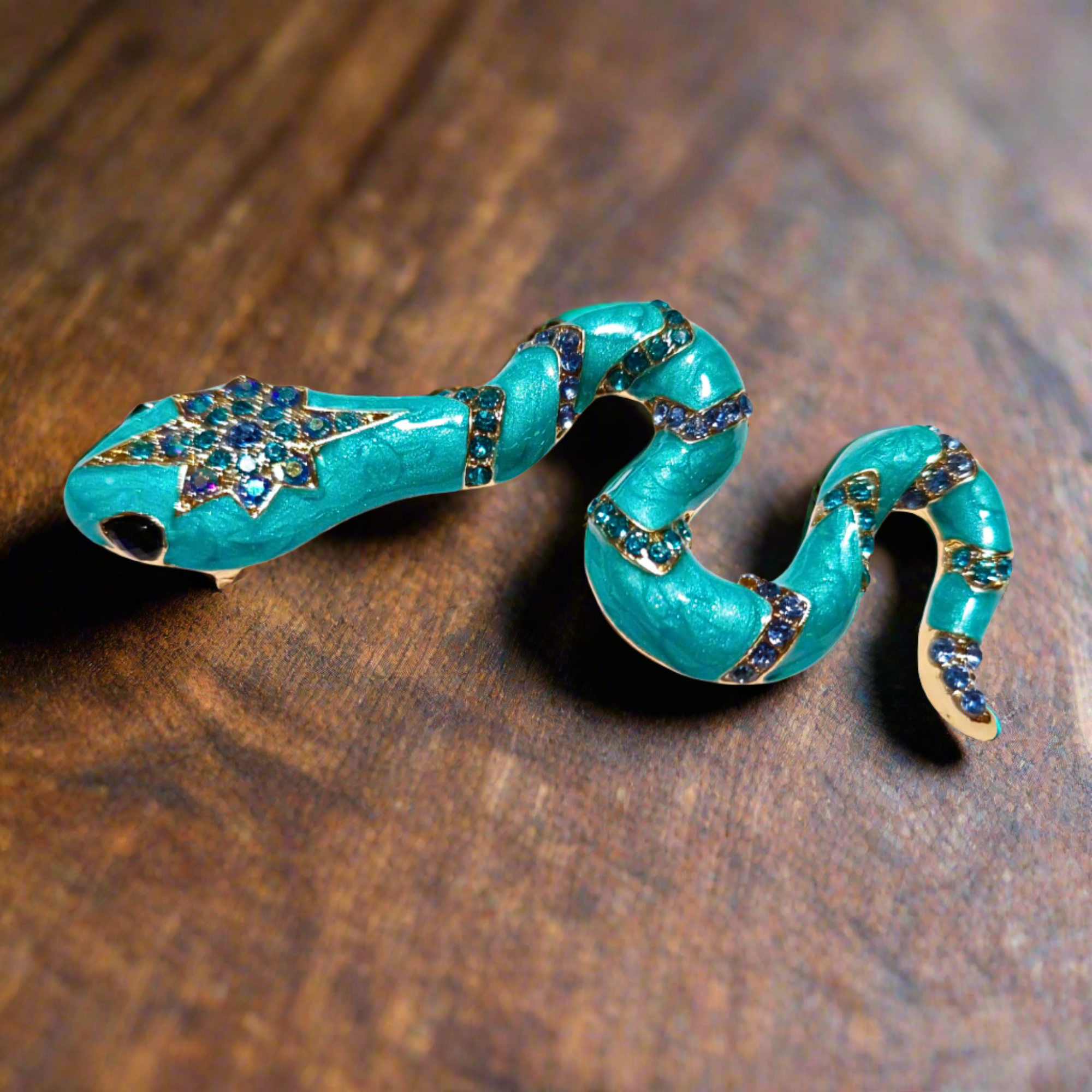 The unique serpent lapel pin displayed elegantly against a dark background, highlighting its beauty.