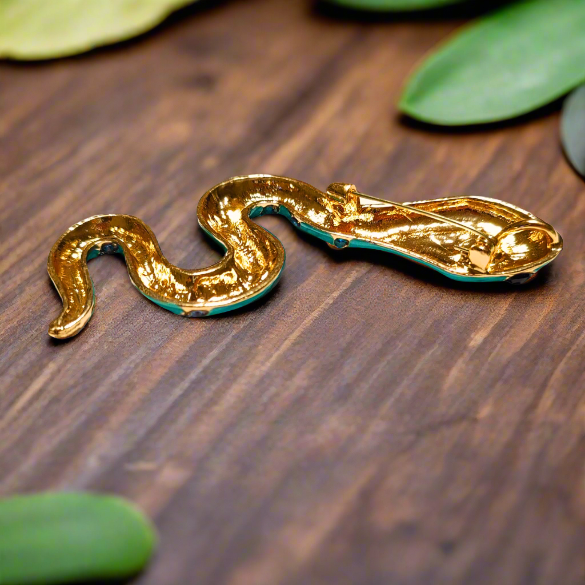 Close-up view of the luxury gemstone snake lapel pin showing vibrant colors and intricate design.