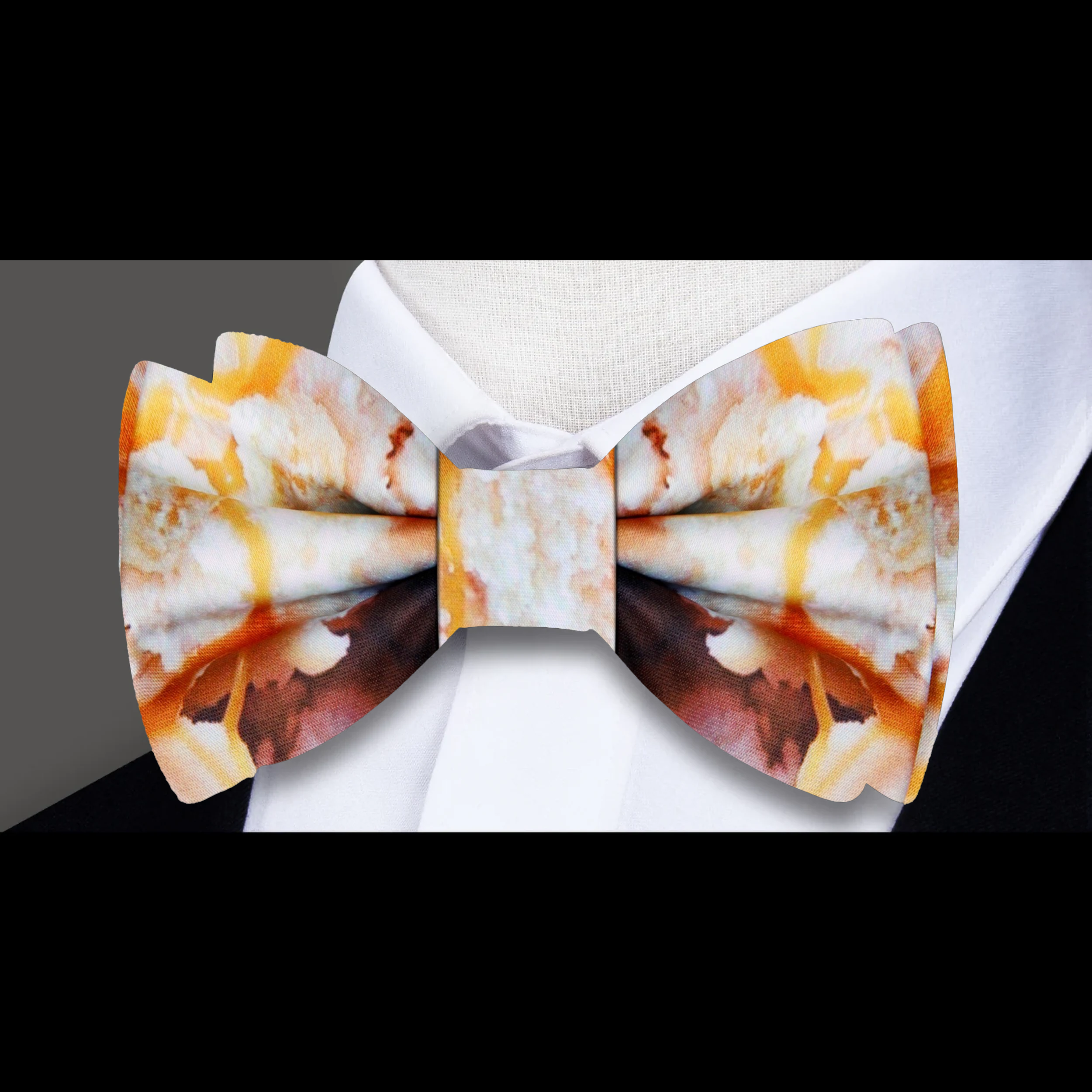 Bow tie displayed on a tan suit, highlighting its elegant color combination.
