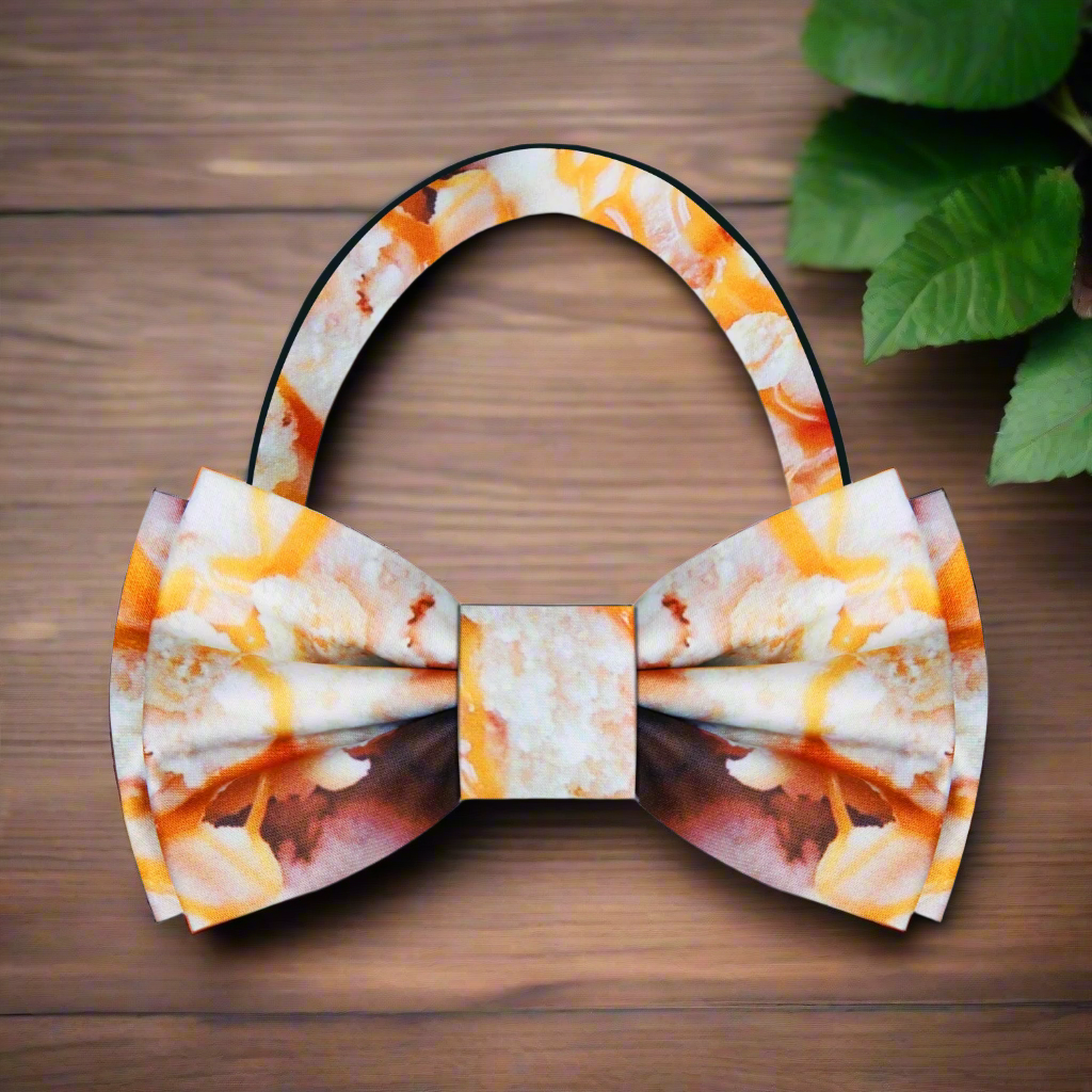 Caramel swirl silk bow tie paired with a crisp white dress shirt for a formal look.