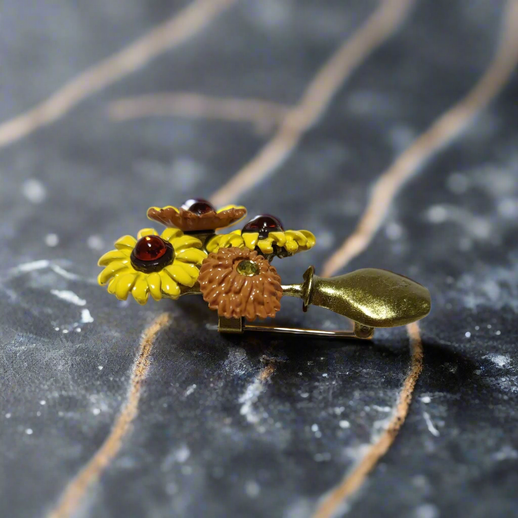 Close-up of the colorful flower pin against a light blue suit
