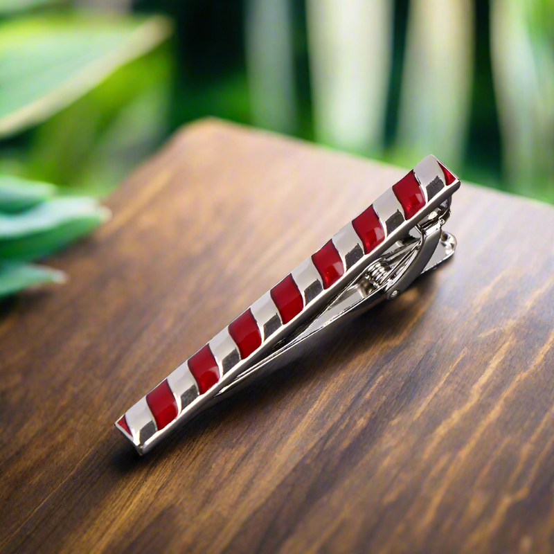 Elegant tie bar in mahogany with chrome floral design, perfect for formal occasions.