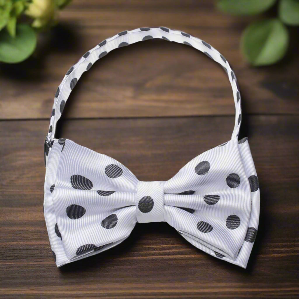 White silk polka dot bow tie styled with a black suit for a wedding