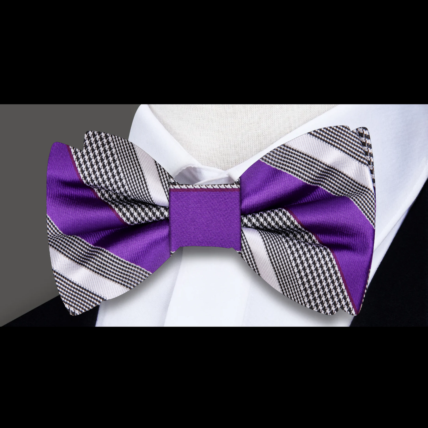 Stylish yellow striped bow tie on a display stand