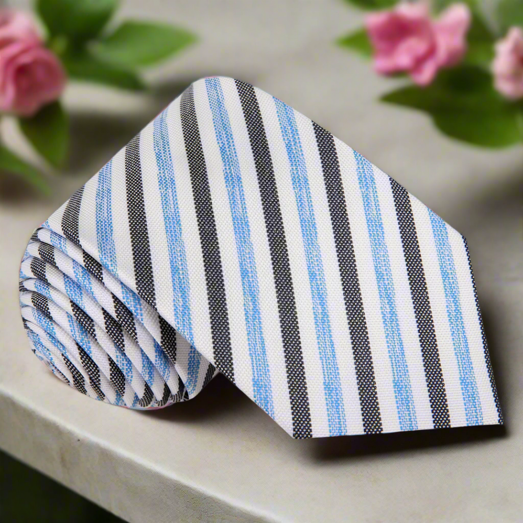 Close-up of a men's silk striped tie in white, blue, and beige