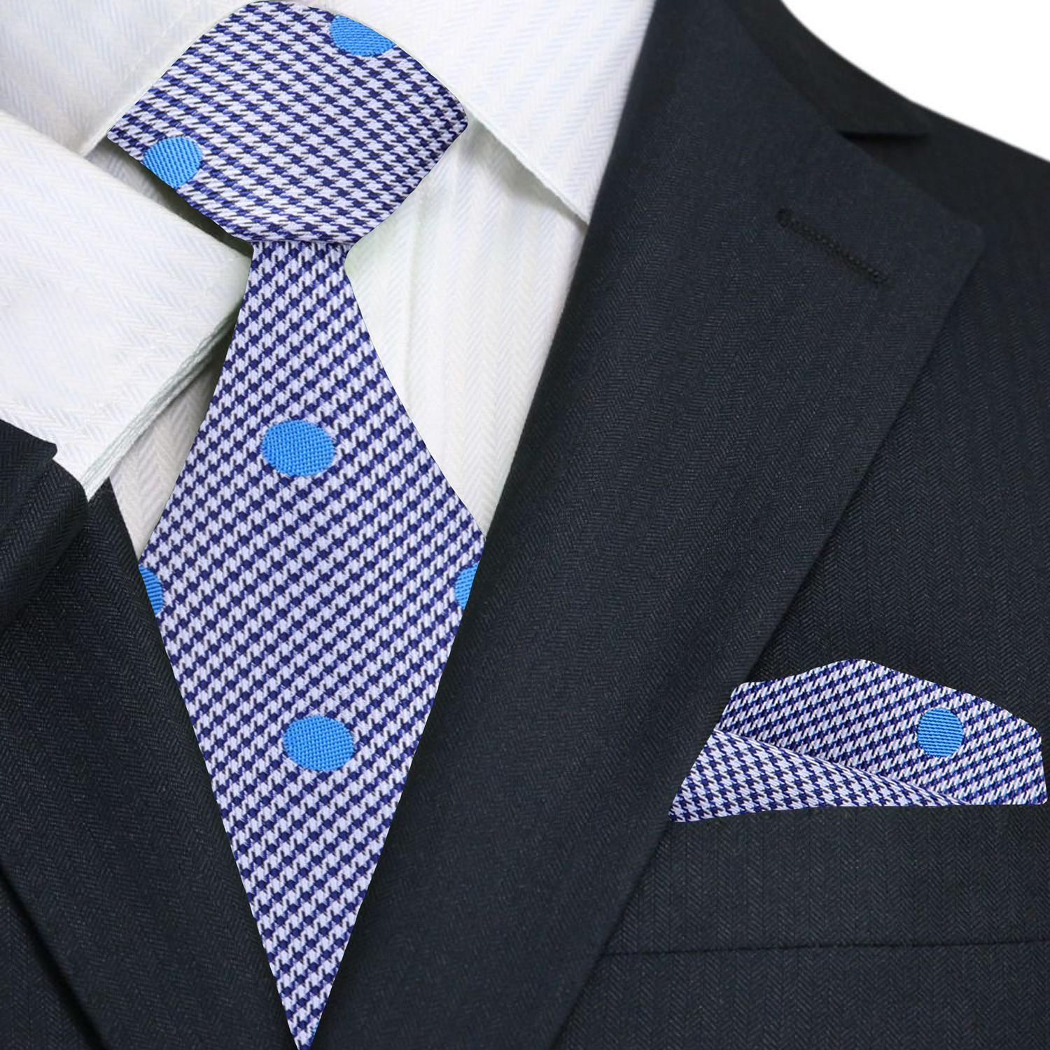 Close-up of the silk tie showing white fabric with blue polka dots, ideal for formal wear