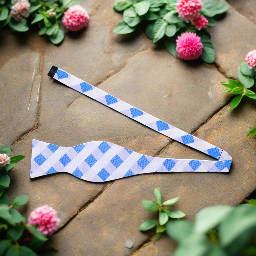 Yellow and blue plaid silk bow tie elegantly displayed on a white background.