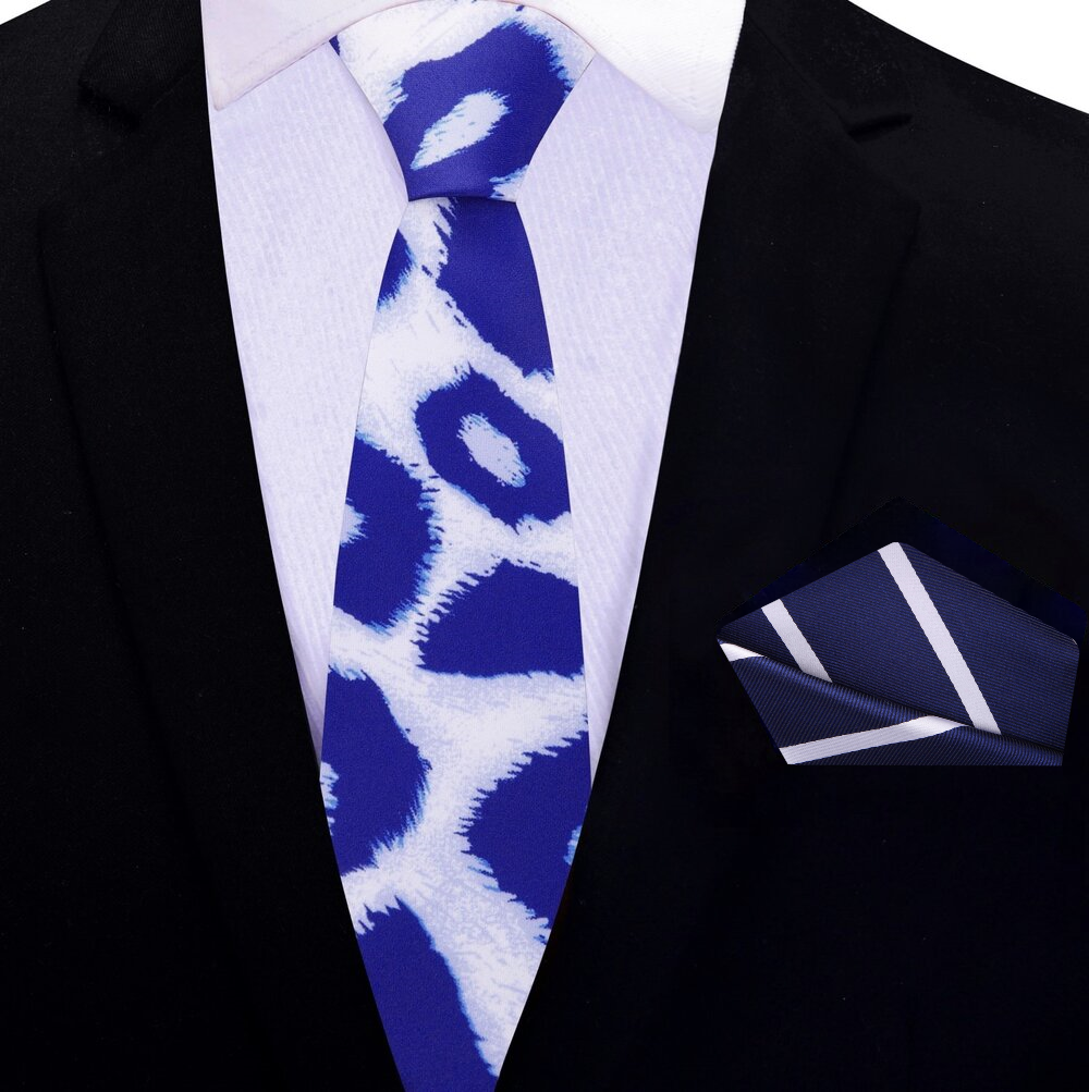 Folded Frostwyke necktie with matching silk pocket square on wooden surface