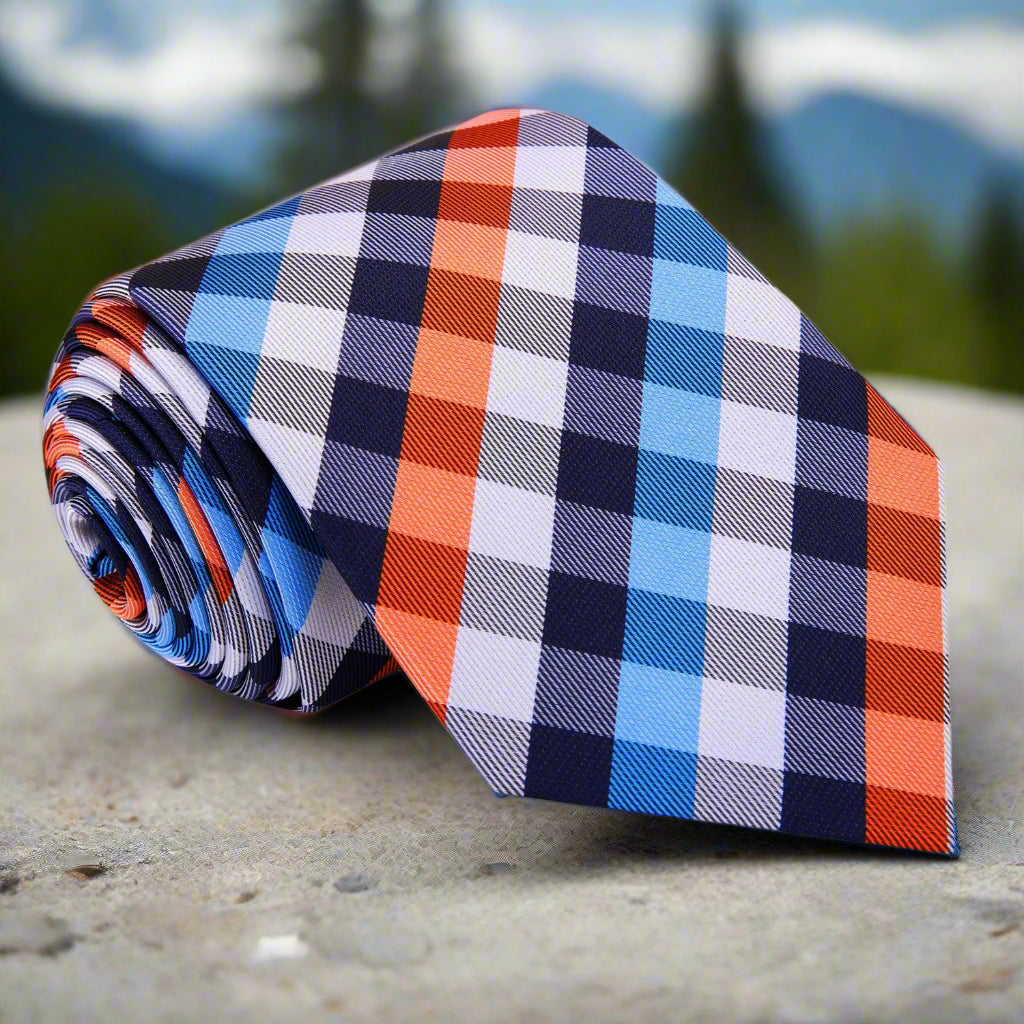 Close-up view of vibrant silk check necktie in white, blue, and orange, showcasing its intricate pattern.