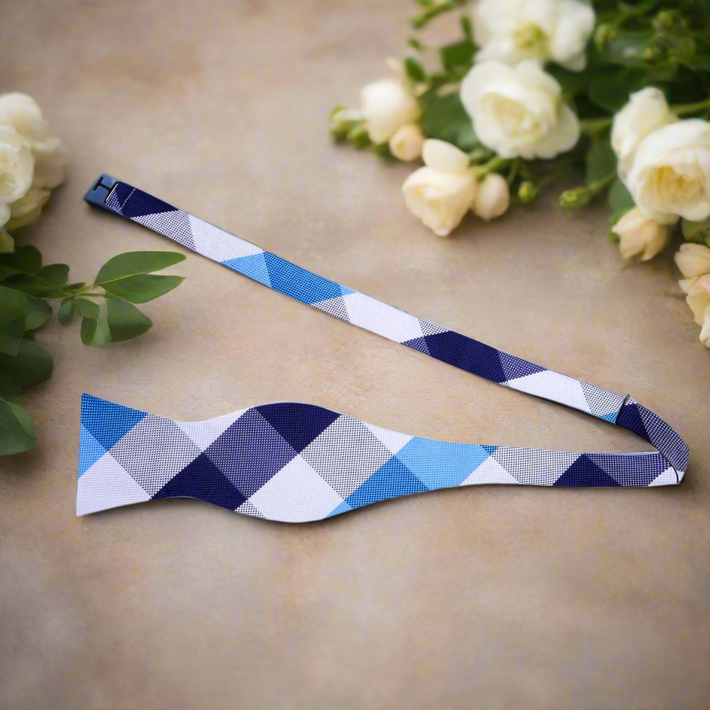 Fashionable man wearing a plaid bow tie with a shirt and blazer, ideal for evening outings