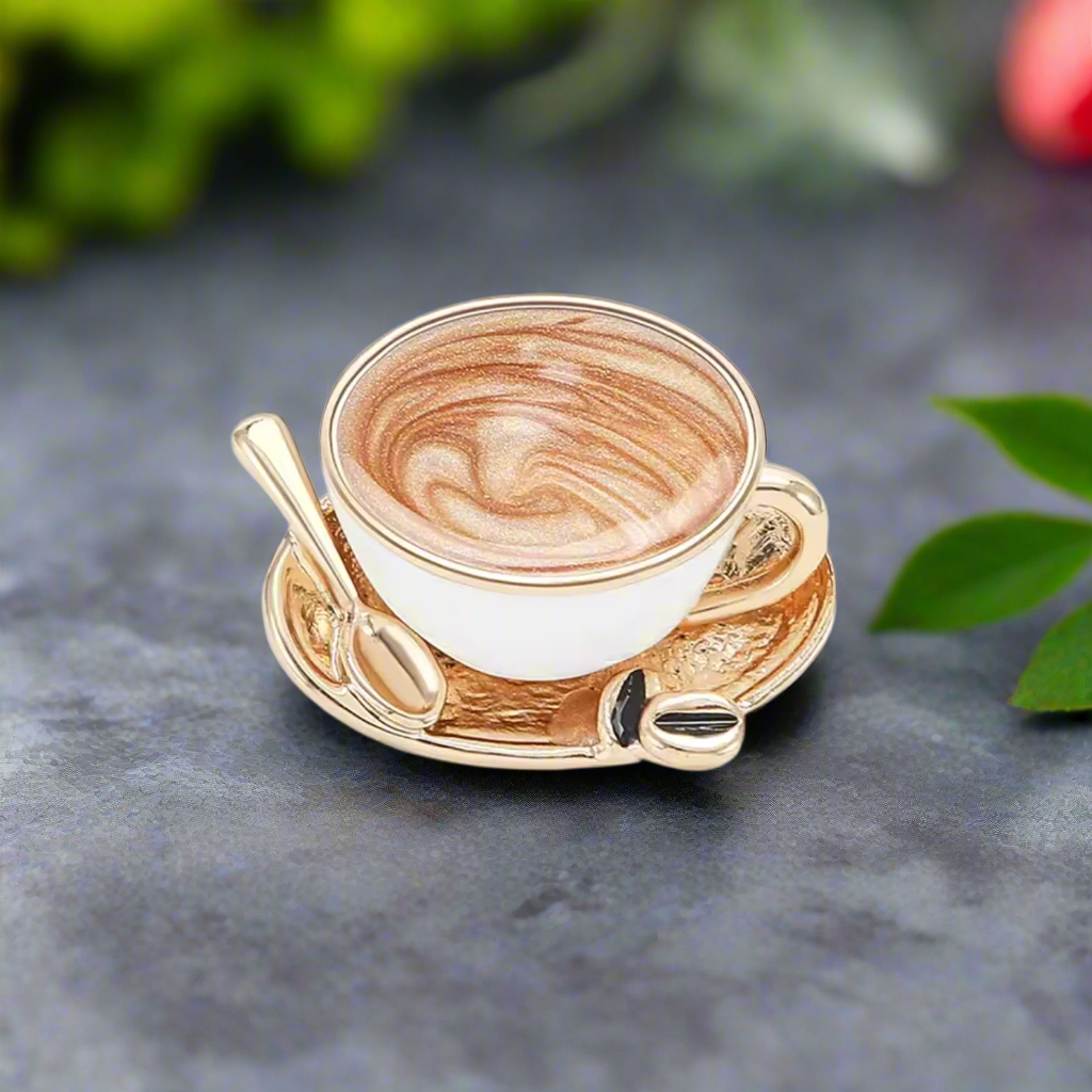 Coffee lapel pin displayed next to coffee beans and a saucer, emphasizes the perfect gift for coffee lovers.