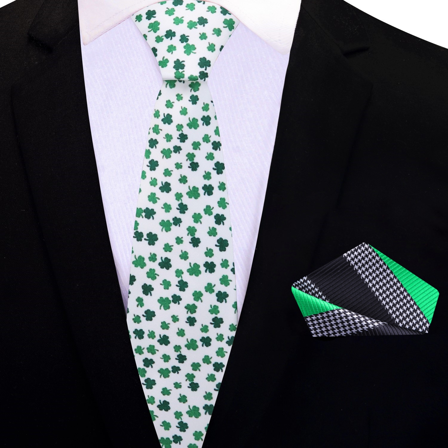 Flat lay of the Irish Pride tie next to a shamrock for St. Patricks Day decor.