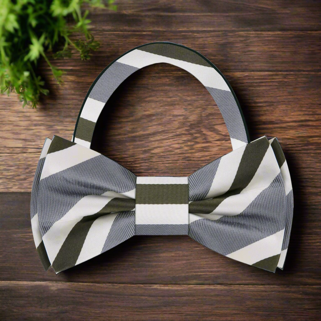 Stylish man wearing a striped bow tie for weddings, paired with a light blue shirt and charcoal suit, exuding elegance.
