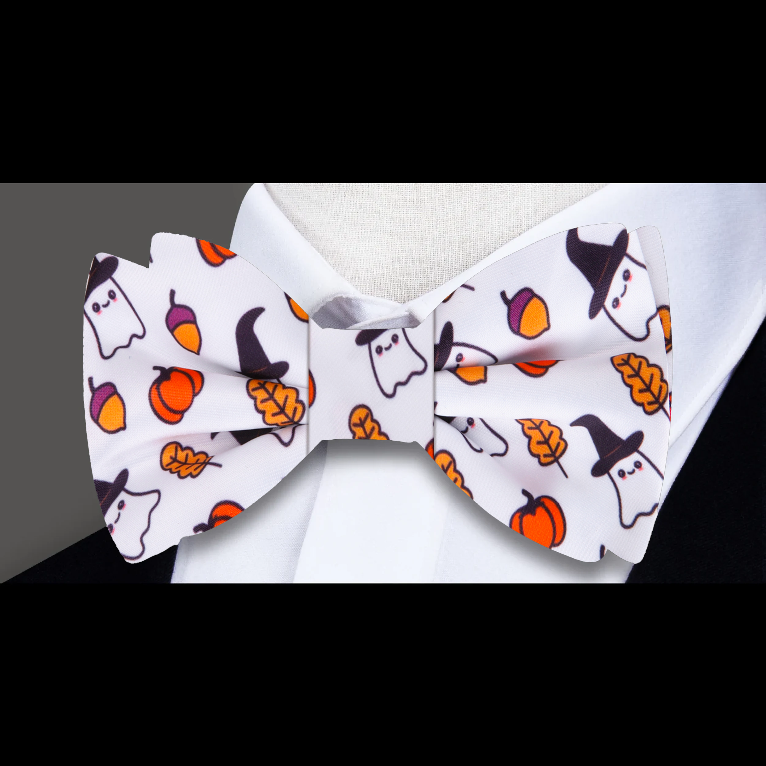 Flat lay of the Halloween silk bow tie alongside matching accessories like a pocket square.