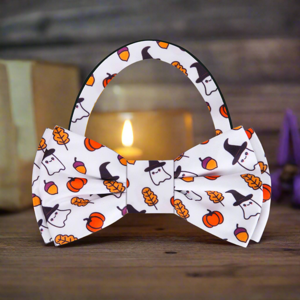 Close-up of the Halloween silk bow tie showcasing the intricate ghost and pumpkin patterns.