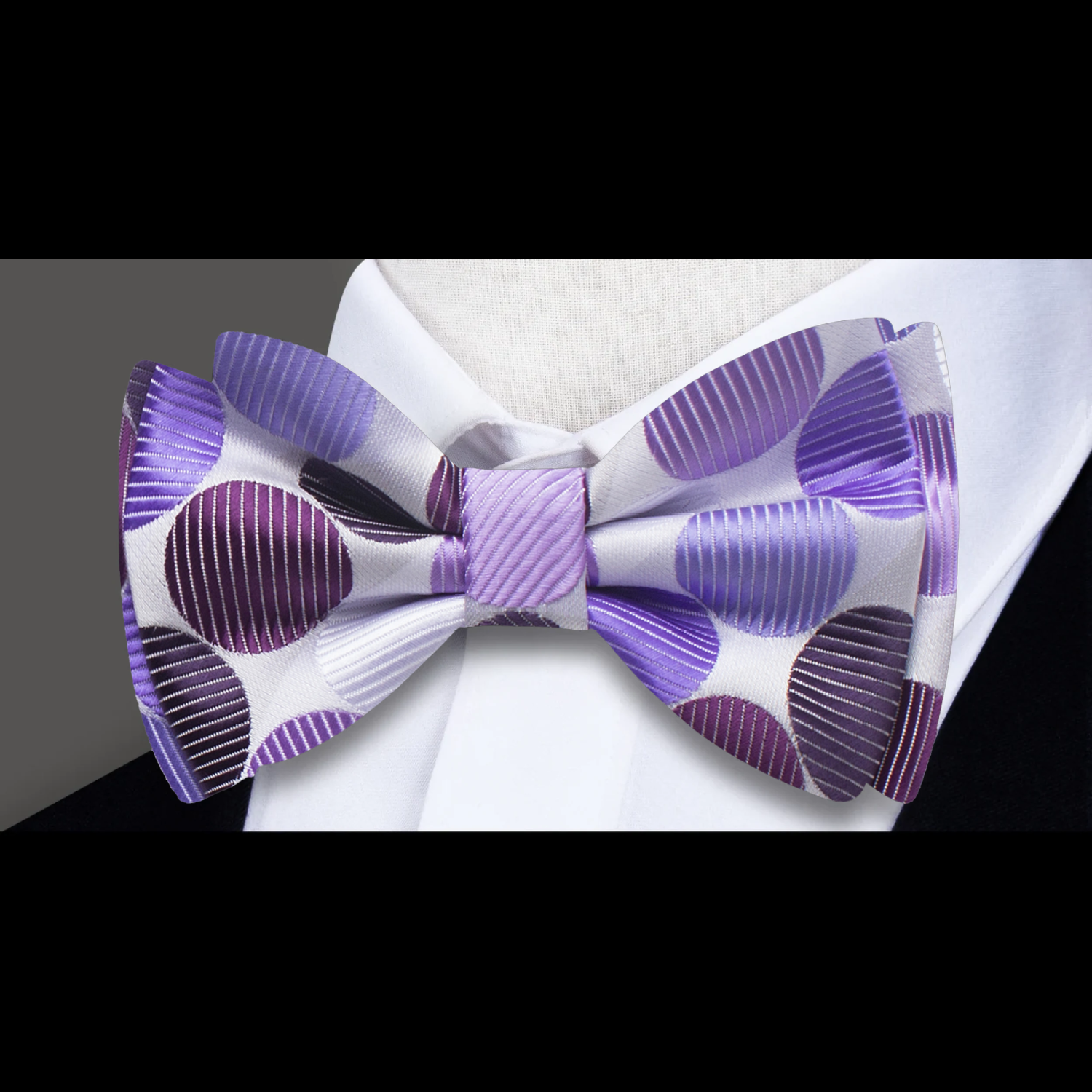 Elegant polka dot bow tie with matching pocket square paired with a light grey suit