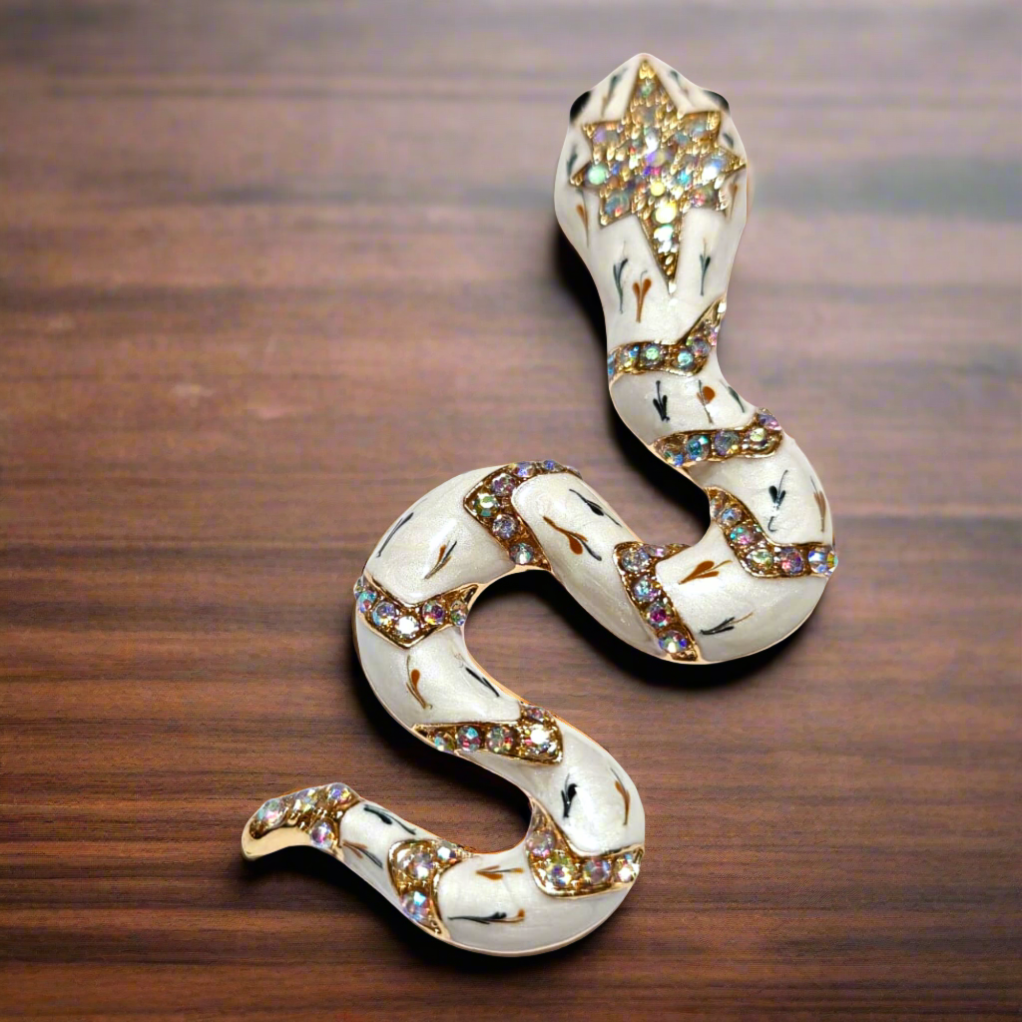 The unique serpent lapel pin displayed elegantly against a dark background, highlighting its beauty.