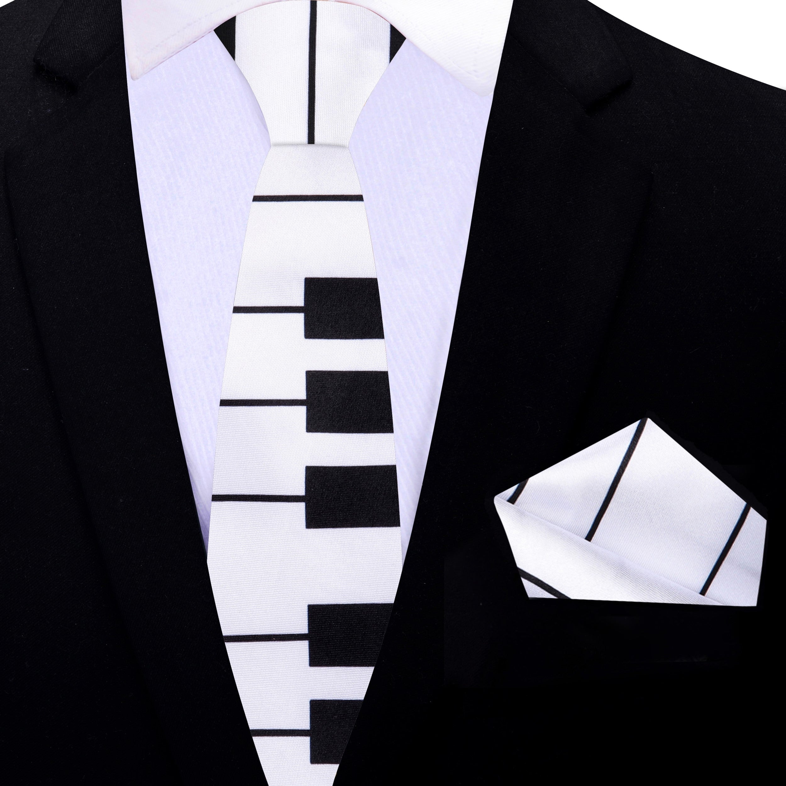 Model wearing the piano keys necktie with a crisp white dress shirt at a concert.