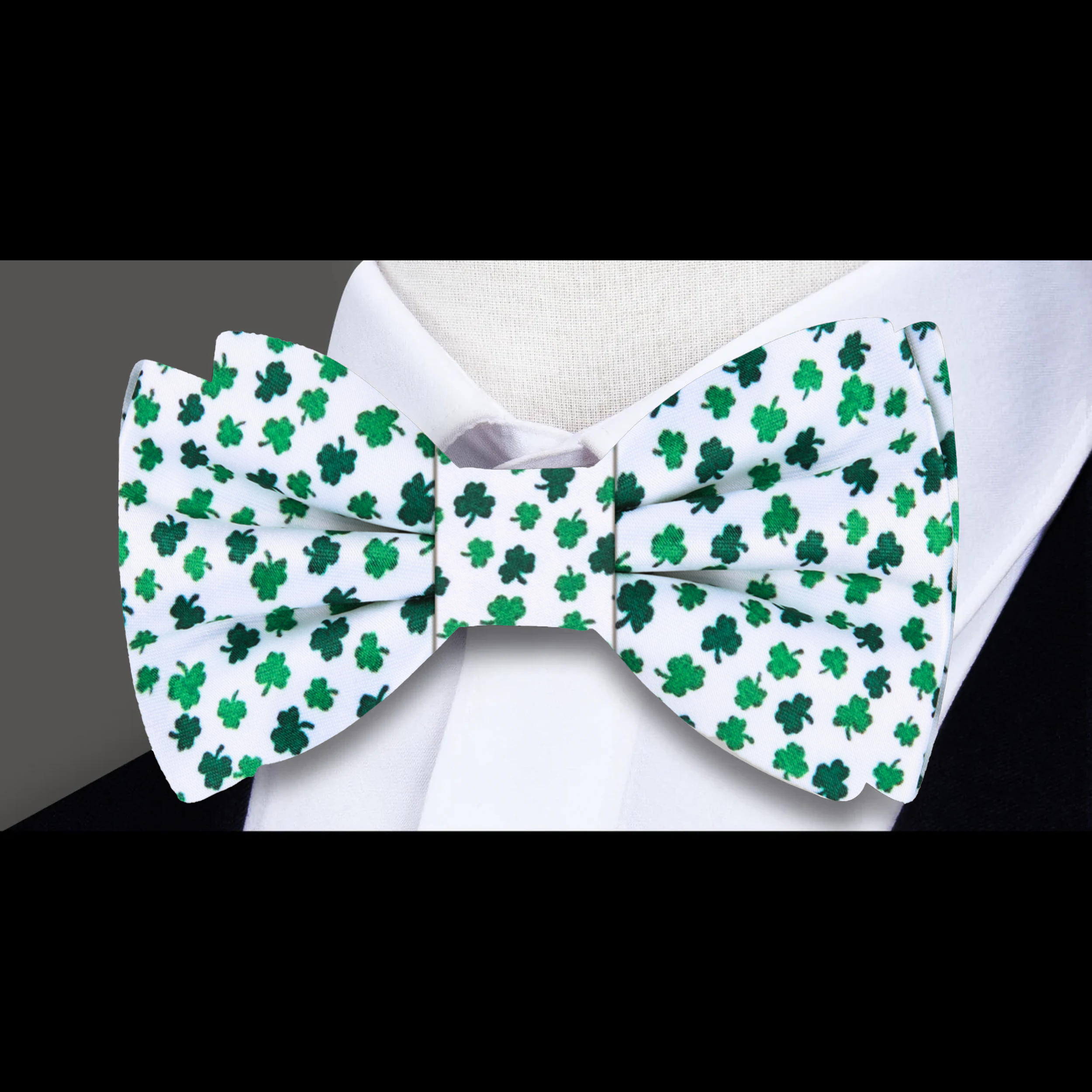 Man wearing a luxury silk bow tie with a four-leaf clover pattern at a St. Patricks Day party.