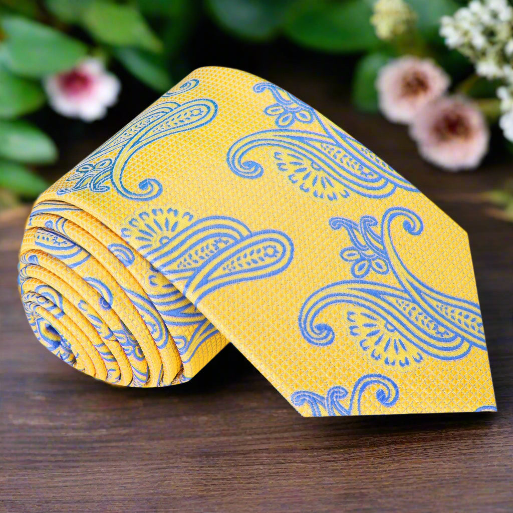 Close-up of yellow paisley tie with intricate pattern for spring weddings