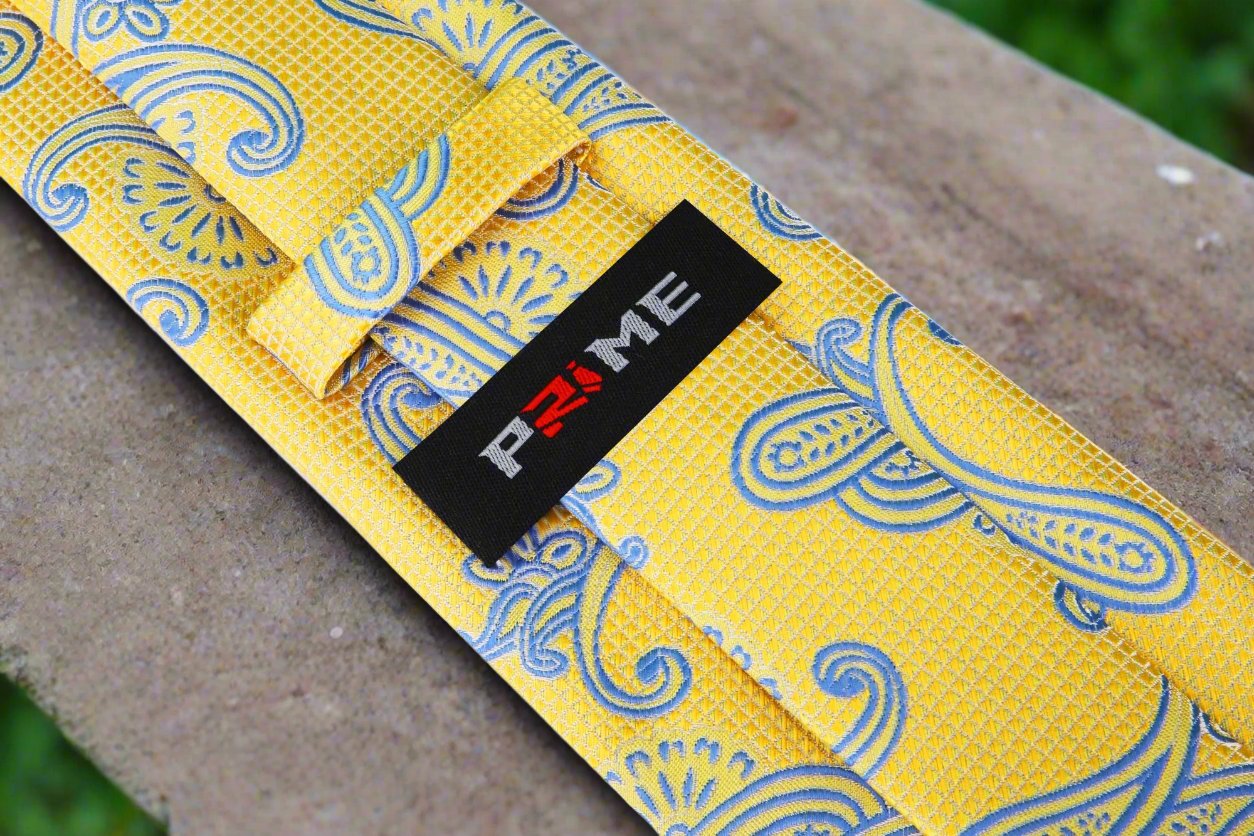 Close-up of yellow paisley tie with intricate pattern for spring weddings