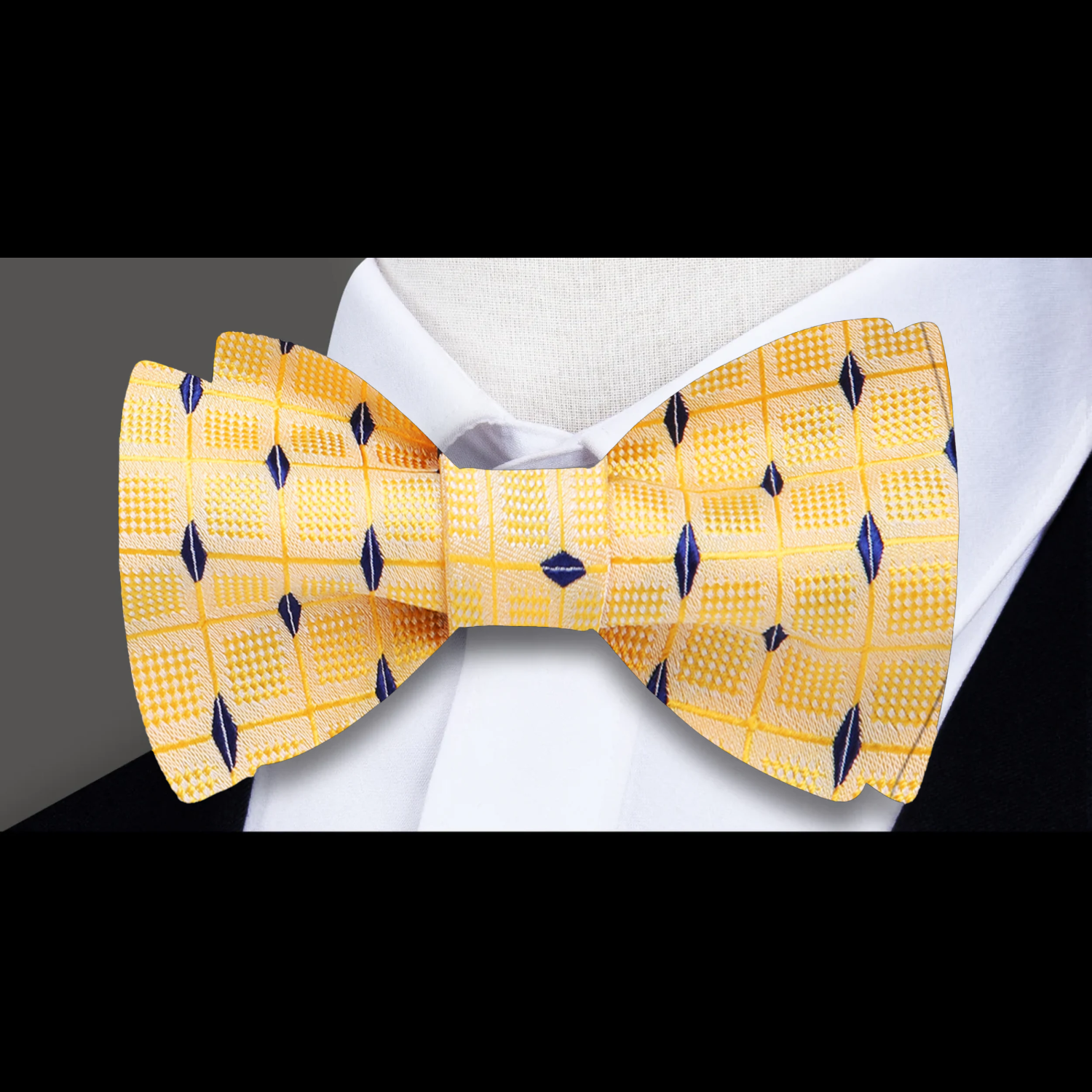 Vibrant yellow silk bow tie paired with a charcoal grey suit, perfect for business events.