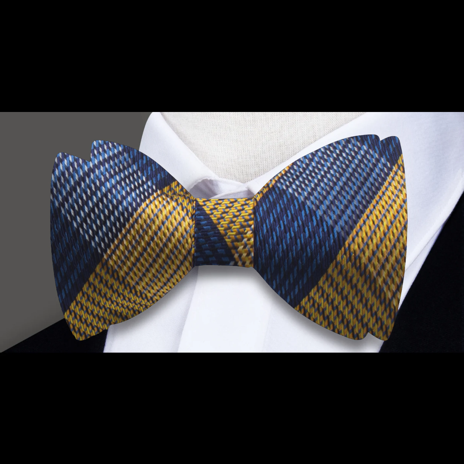 Front view of silk plaid bow tie styled with a dress shirt and suit