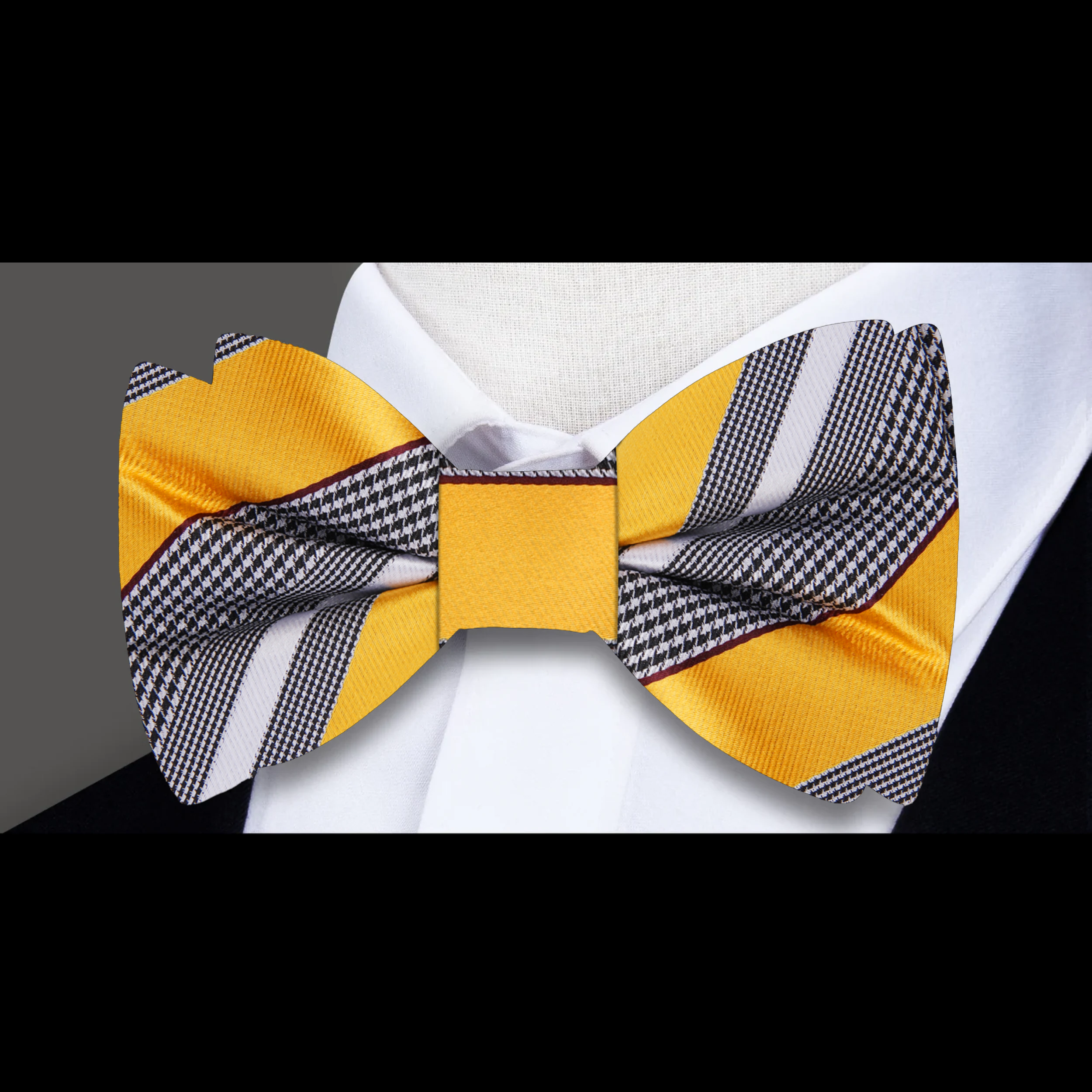 Stylish yellow striped bow tie on a display stand