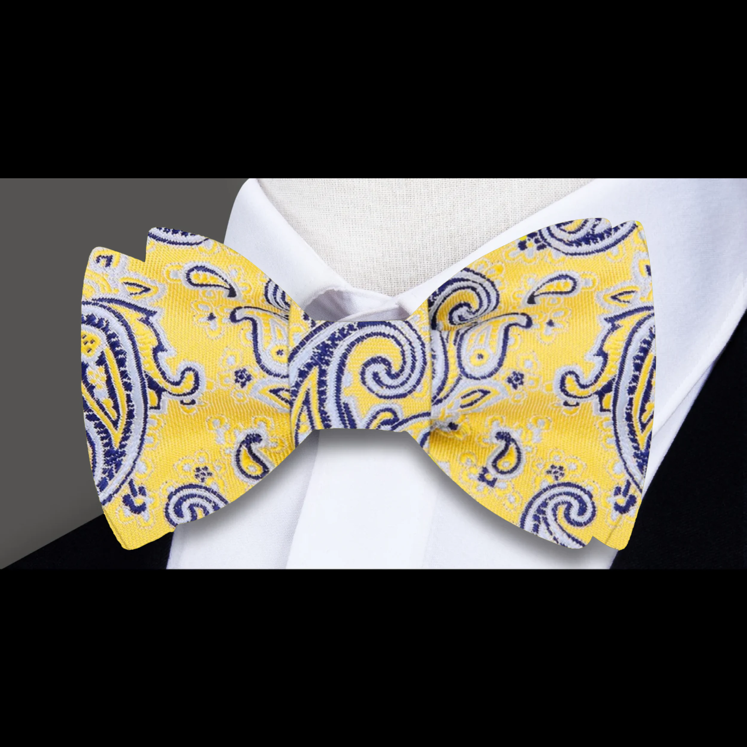 Self tie bow tie displayed against a crisp white dress shirt, highlighting its intricate design.