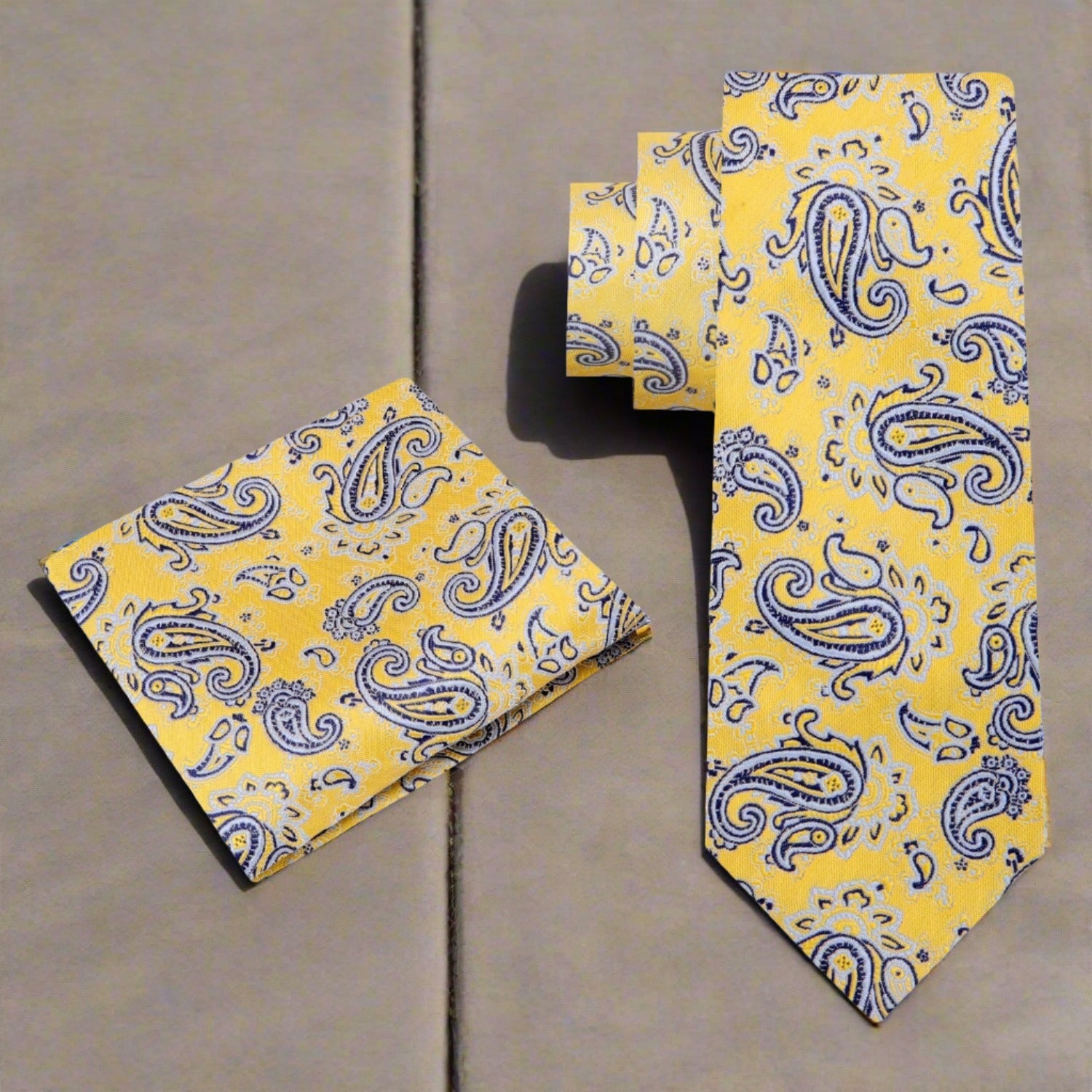 Close-up of stylish paisley silk necktie in yellow and black for formal events