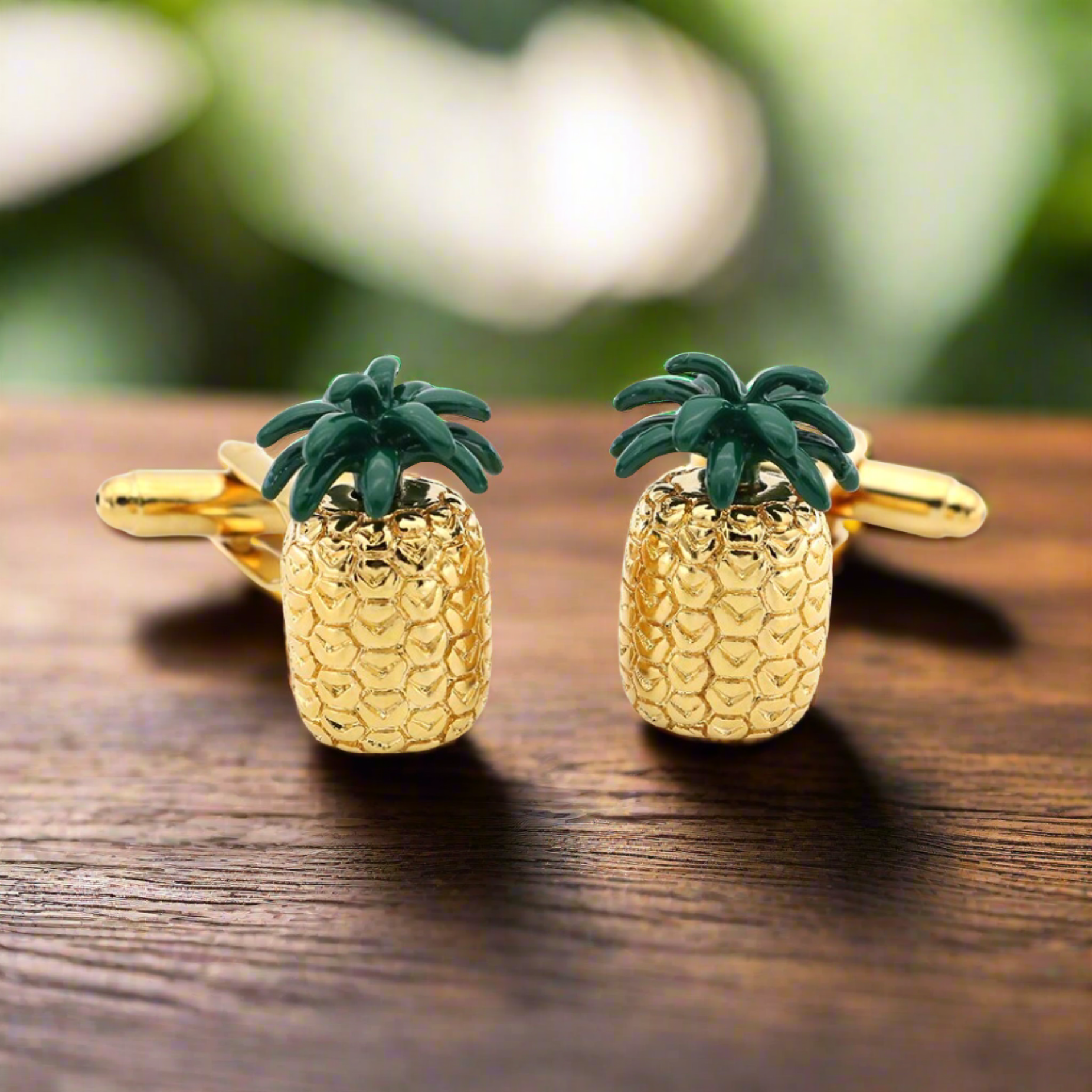 Man wearing pineapple cufflinks with a white dress shirt at a beach party