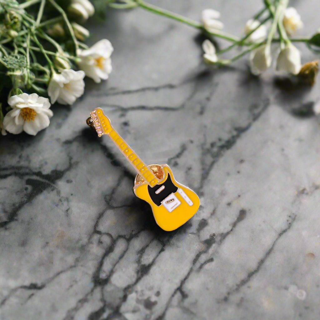 Fashionable music pin featuring a yellow guitar, ideal for music events