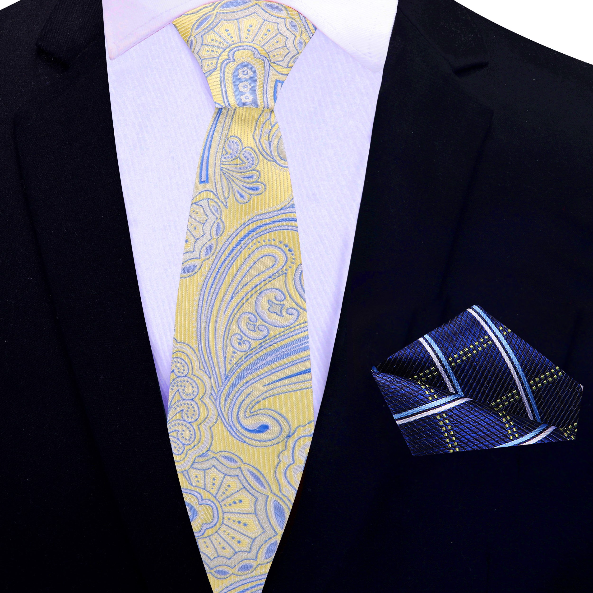 Elegant yellow paisley tie styled with a navy suit at outdoor event